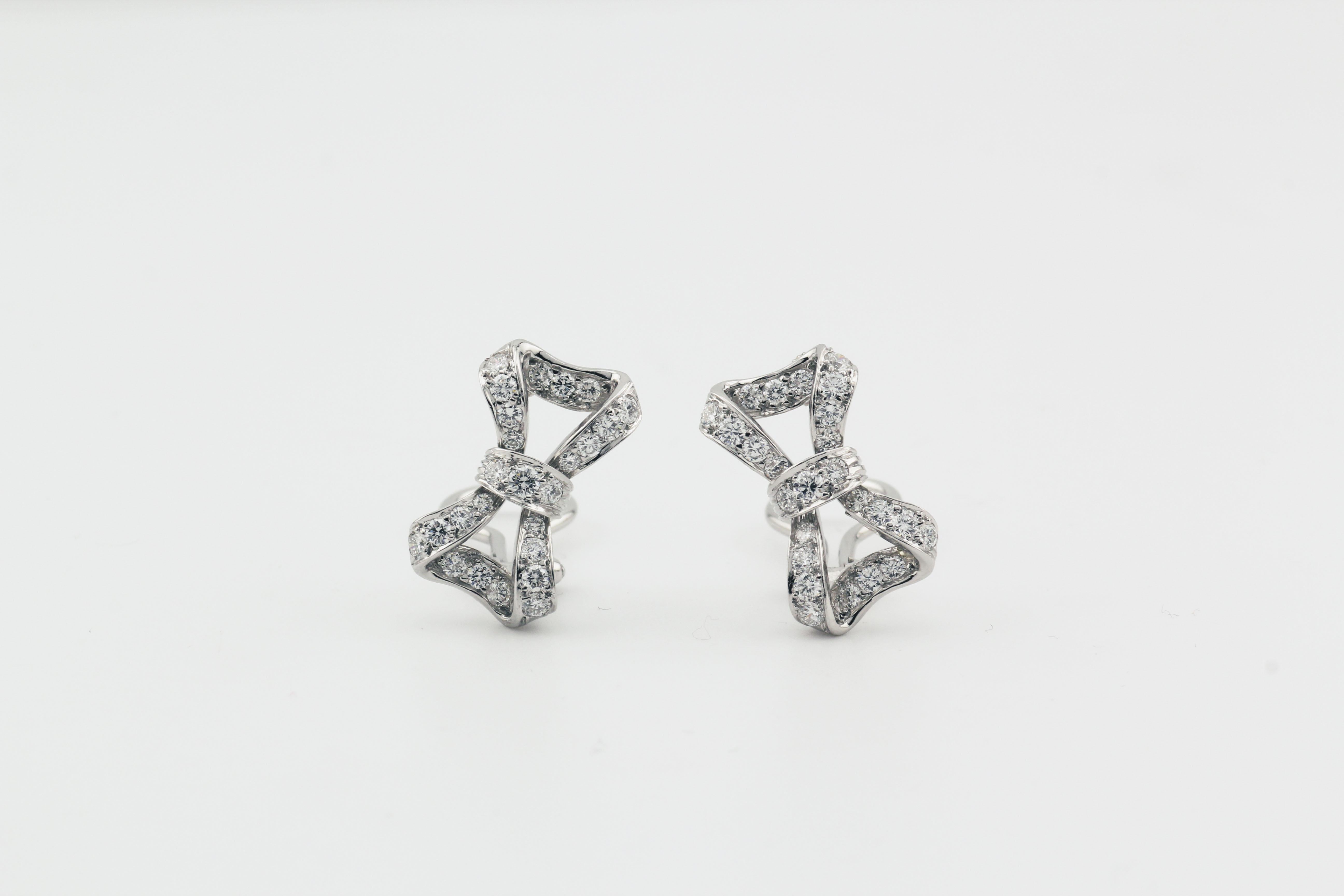 The Tiffany & Co. Diamond Platinum Bow Earrings are a dazzling display of elegance and refined craftsmanship. Crafted in luxurious platinum, these clip-on earrings are designed in a delicate bow shape, symbolizing grace and femininity. The intricate