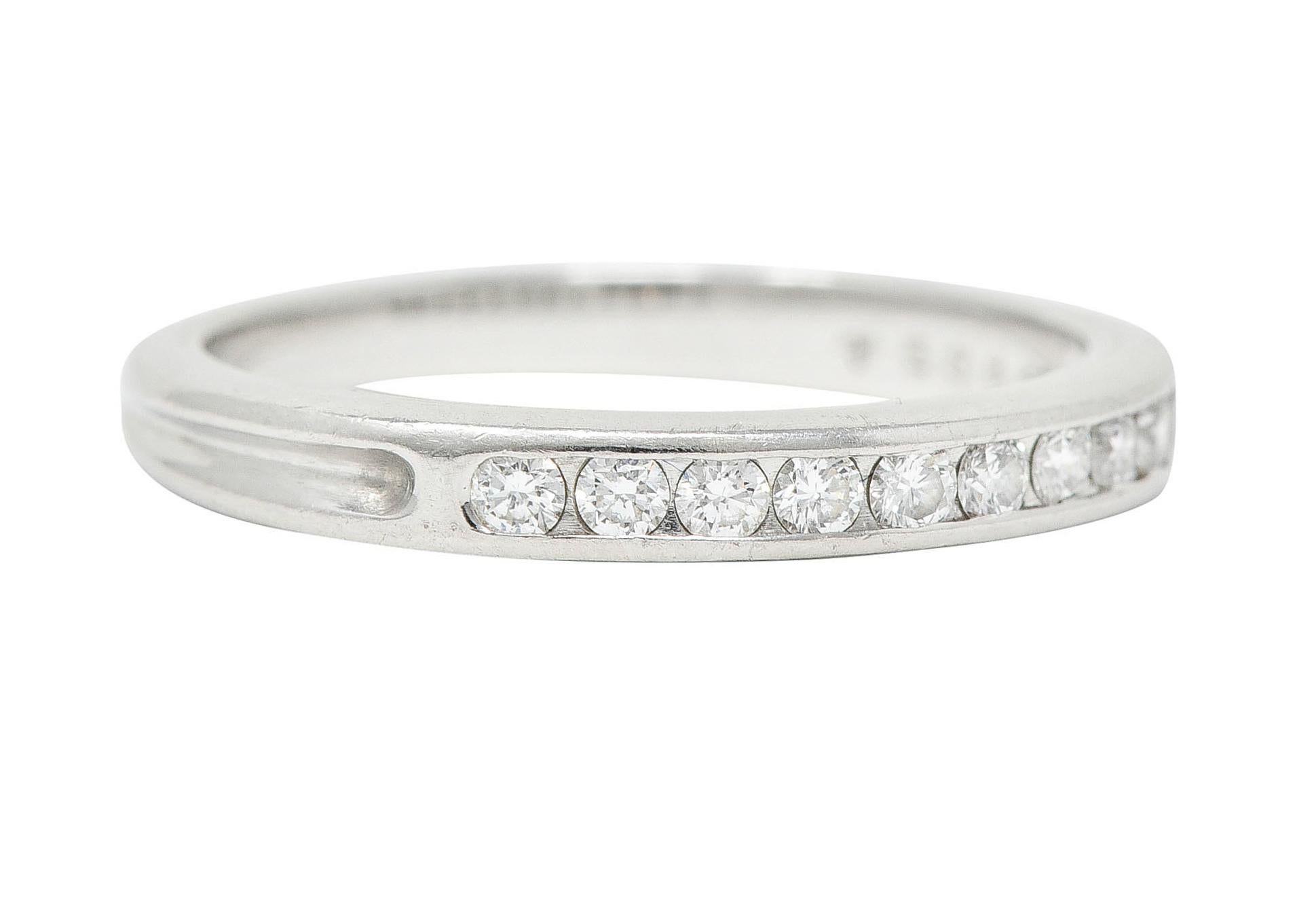 Band features channel set round brilliant cut diamonds weighing approximately 0.25 carat in total

Diamonds are G/H in color with VS clarity

Completed by grooved shoulders and sleek shank

Stamped PT950 for platinum

Fully signed Tiffany &