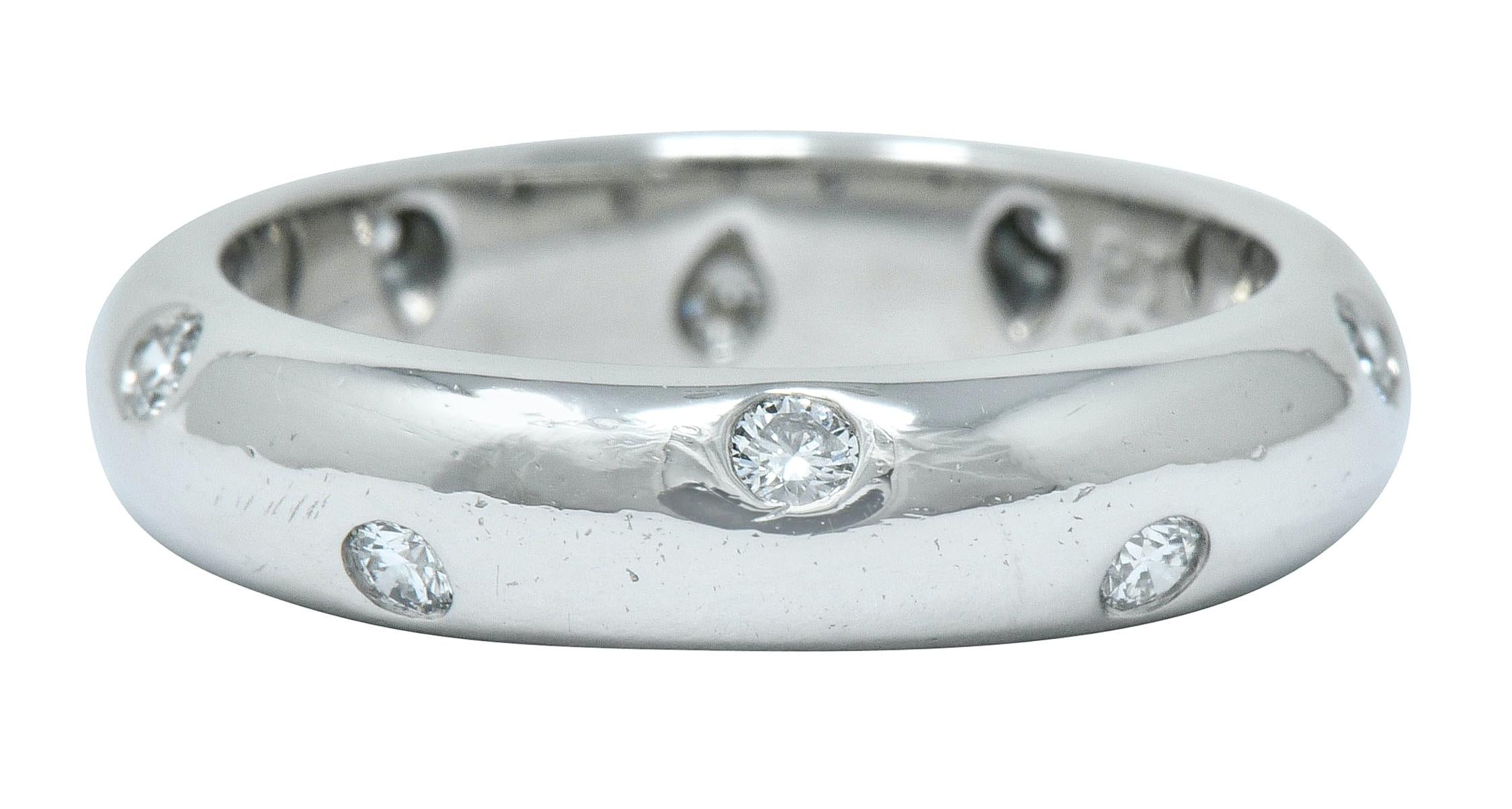 Band style ring polished bright with rounded curvature

Flush set with nine round brilliant cut diamonds weighing approximately 0.22 carat; F/G color with VS clarity

Signed T & Co. and stamped PT950 for platinum

From the contemporary Etolie