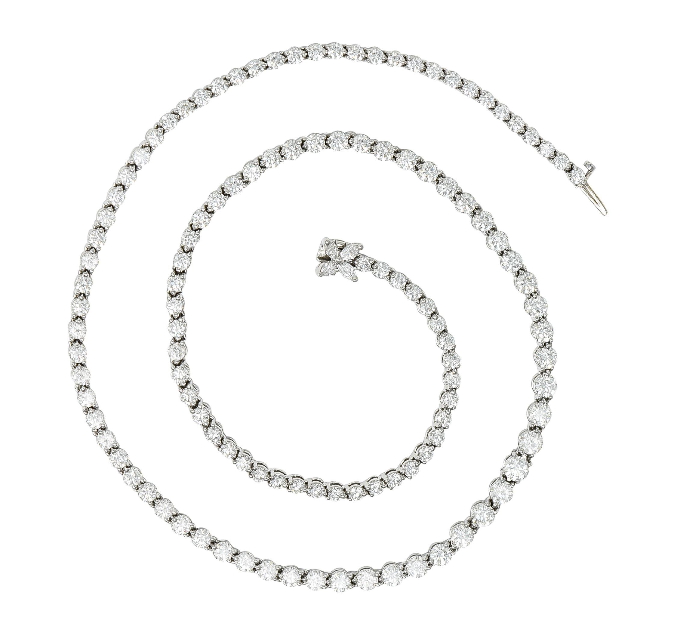 Designed as hinged platinum basket links each centering round brilliant cut diamonds. Weighing approximately 10.18 carats total - F/G color with VS clarity. Prong set and graduating in size with stylized floral clasp. Featuring well matched prong