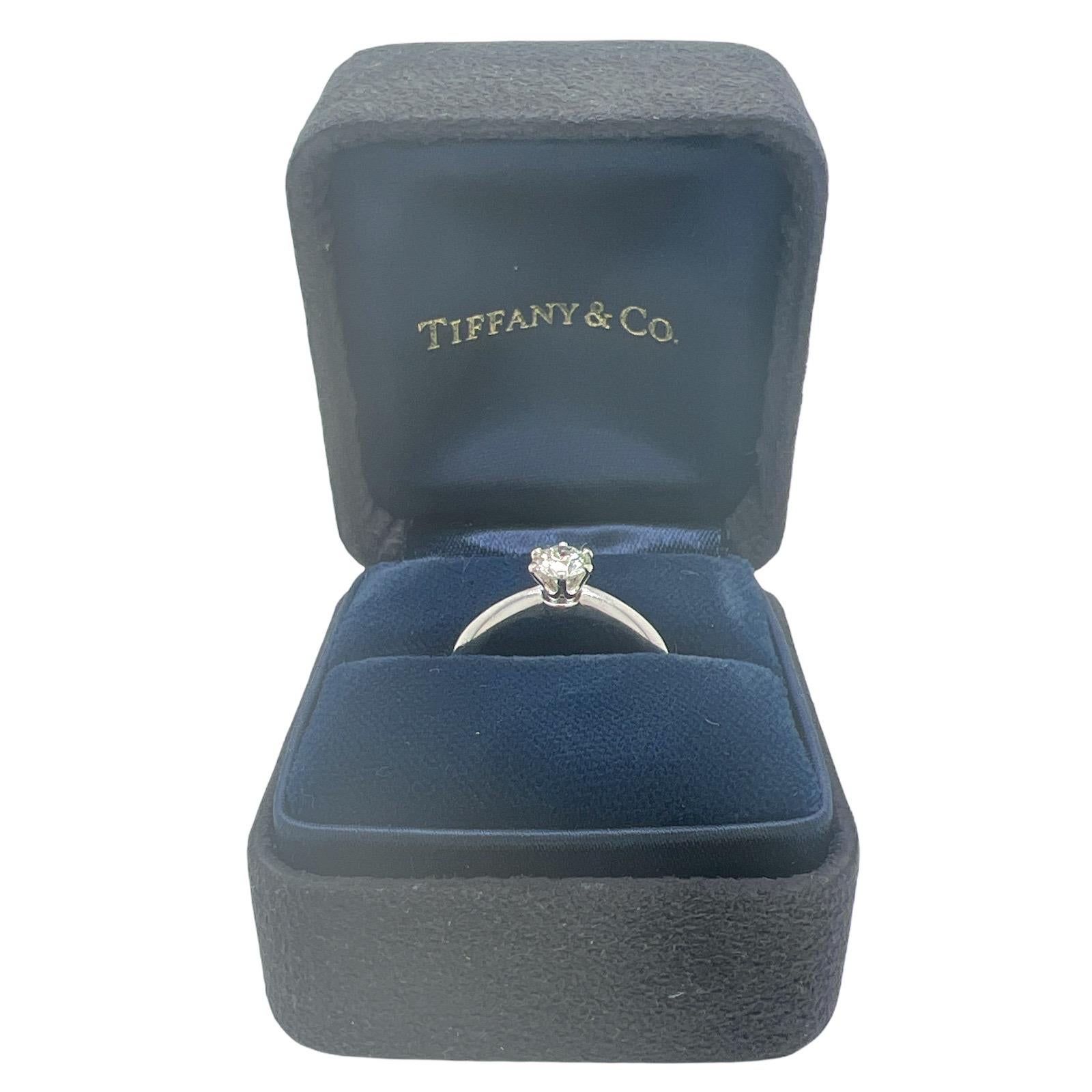 Tiffany & Co. Diamond Platinum Engagement Ring with original Box & Papers. The ring features a .37 carat round brilliant cut diamond graded I color and VS1 clarity. The platinum 6 prong mounting is currently size 5.5 (can be sized). The ring is
