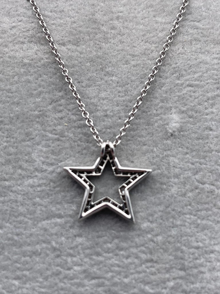 Sparkling figural diamond star necklace. Made and signed by TIFFANY & CO.  Set in platinum on the original 16