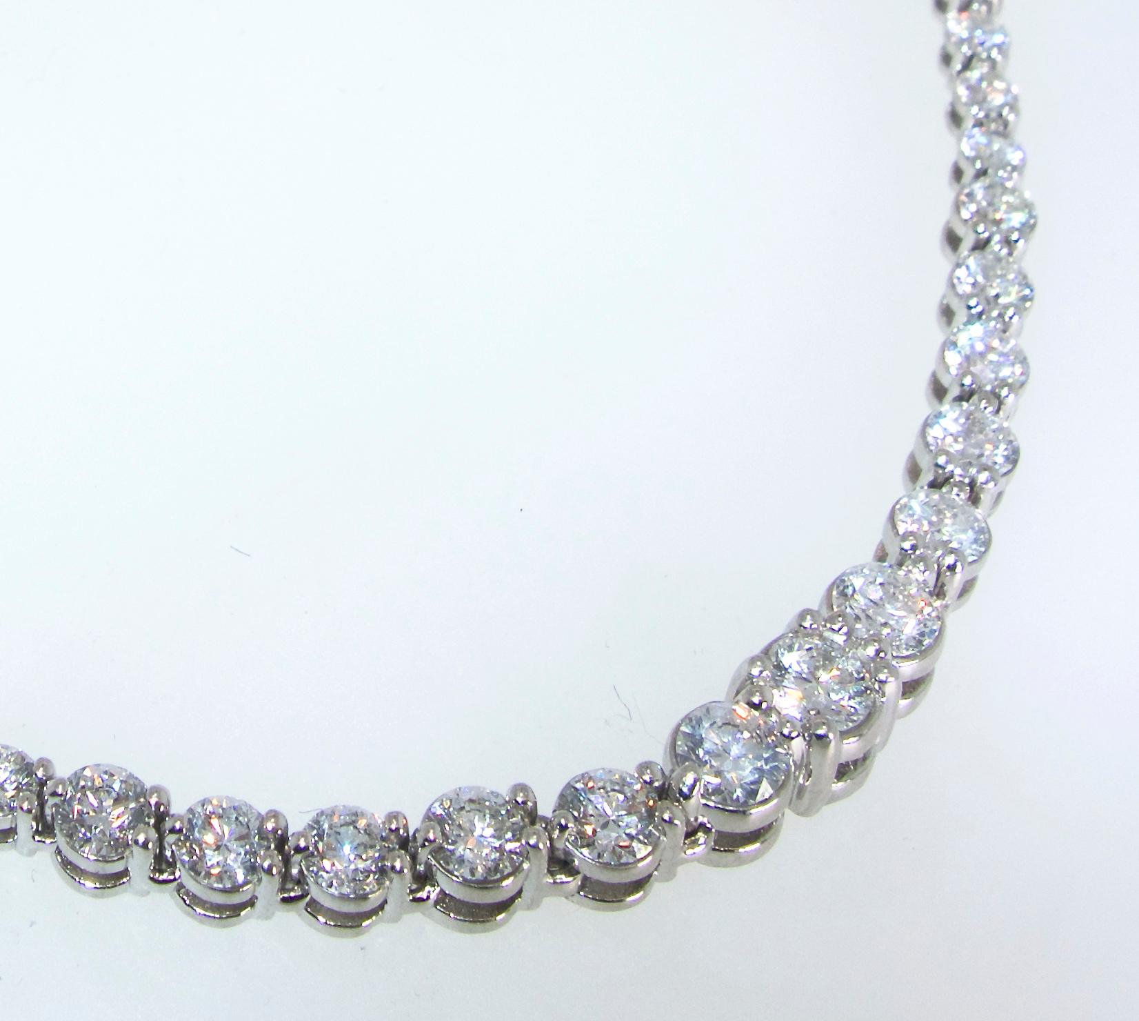 Platinum diamond Riviere necklace possessing well matched, well cut, fine diamonds totaling approximately 13 cts.  These 89 brilliant cut diamonds, ranging in size from .15 cts. up to .45 cts.,  are all near colorless (H) and very slightly included