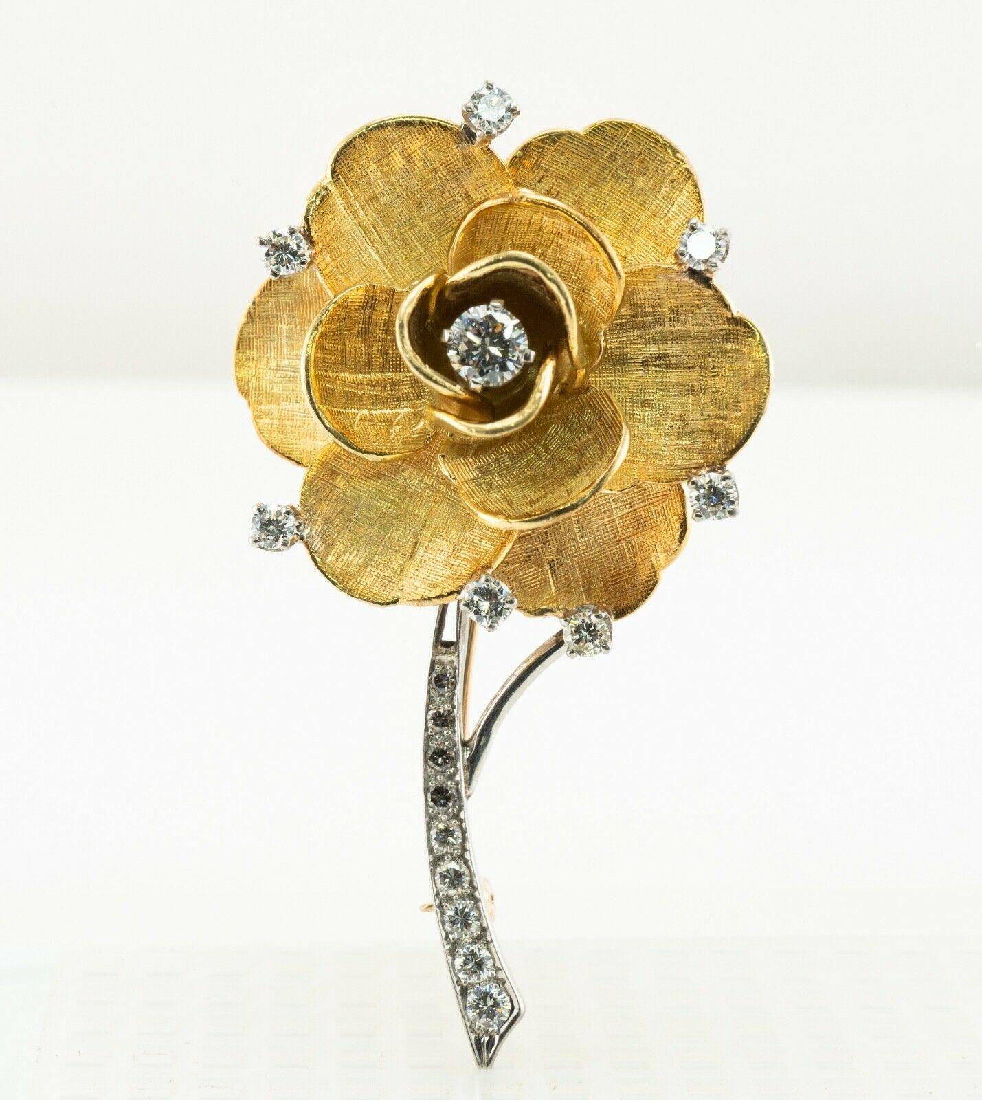 This authentic Tiffany & Co brooch is finely crafted in solid 18K Yellow and White Gold in the shape of beautiful flower. Rare and unique, highly collectible. The center round brilliant cut diamond is .33 carat. Seven smaller diamonds are .08 carat
