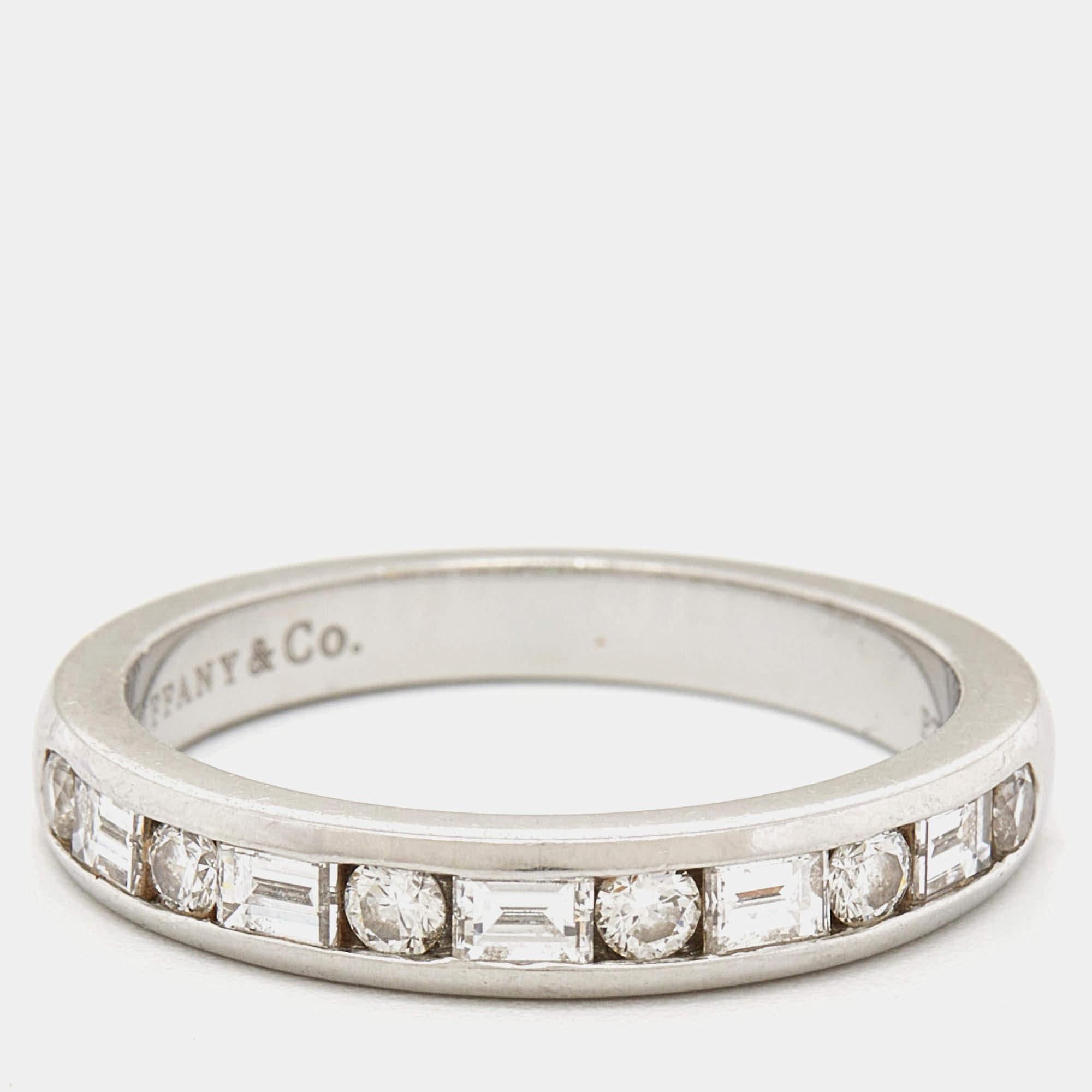 The Tiffany & Co. ring is a stunning piece of jewelry. Crafted in platinum, it features a channel setting with both round and baguette-cut diamonds, creating a timeless and elegant design that sparkles with sophistication.

