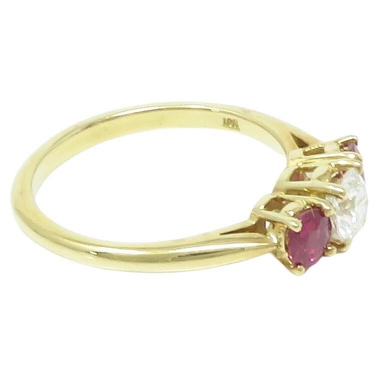 Embrace sophistication with this exquisite Tiffany & Co. ring, crafted in 18k gold and adorned with a 5.0 x 5.0 x 3.0mm diamond weighing approximately 0.5 carats, in the E-F color range and VS clarity. Surrounding the diamond are stunning rubies
