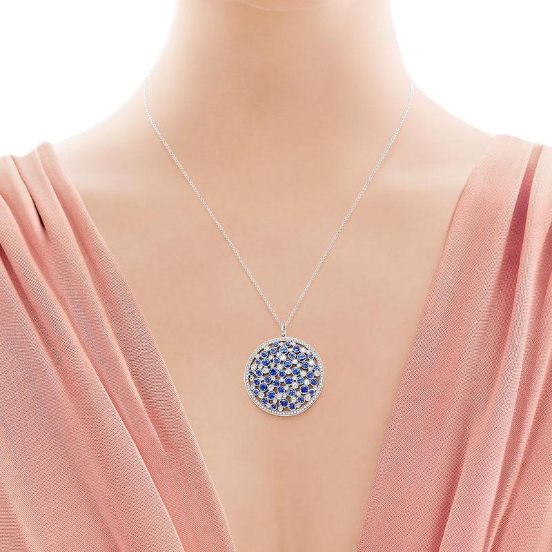 This exquisite medallion pendant necklace by Tiffany & Co is full of dazzling round sapphires and round brilliant diamonds. This pendant comes on an 18