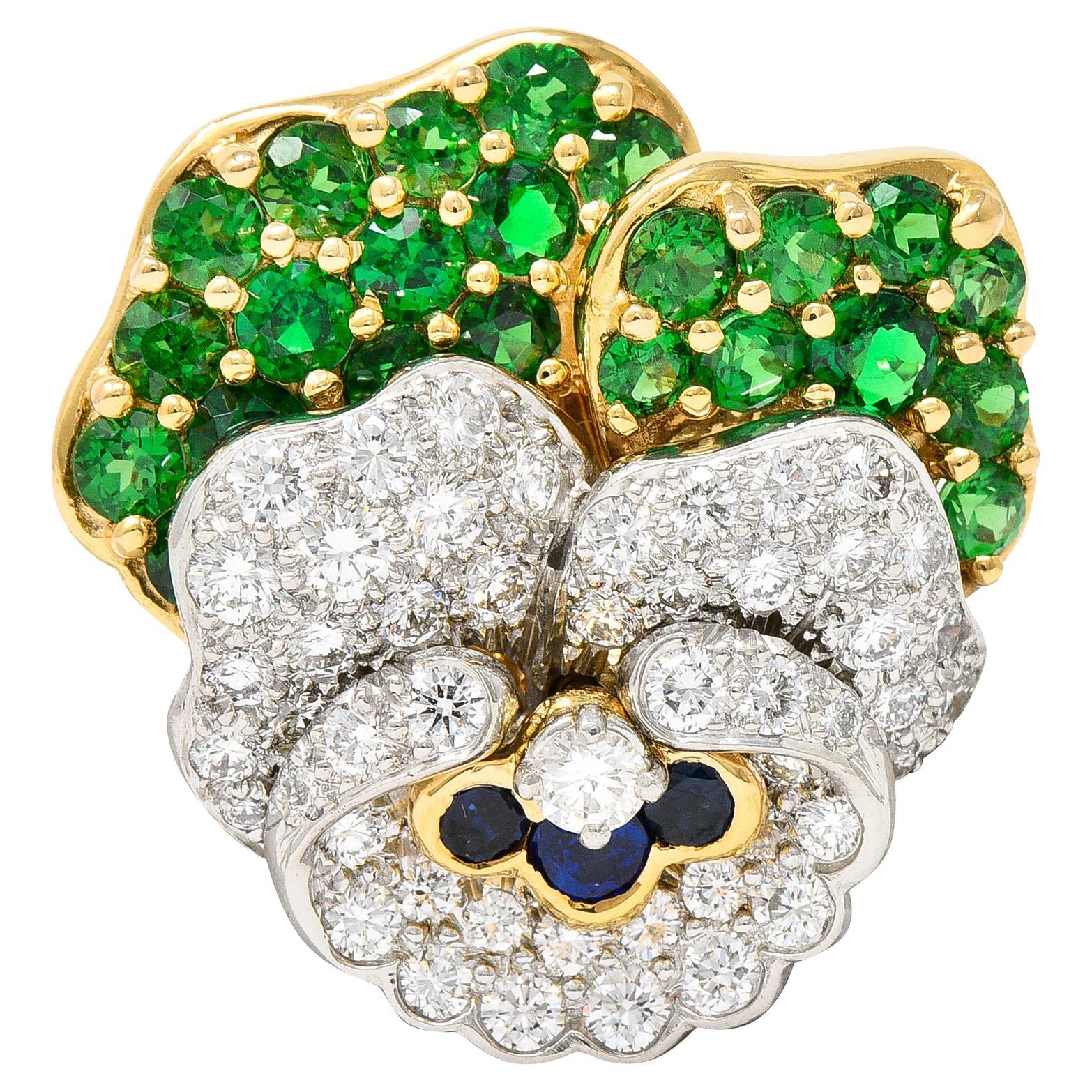 Tiffany & Co. Broche panthère en or jaune 18 carats, platine, diamants, saphirs et grenats