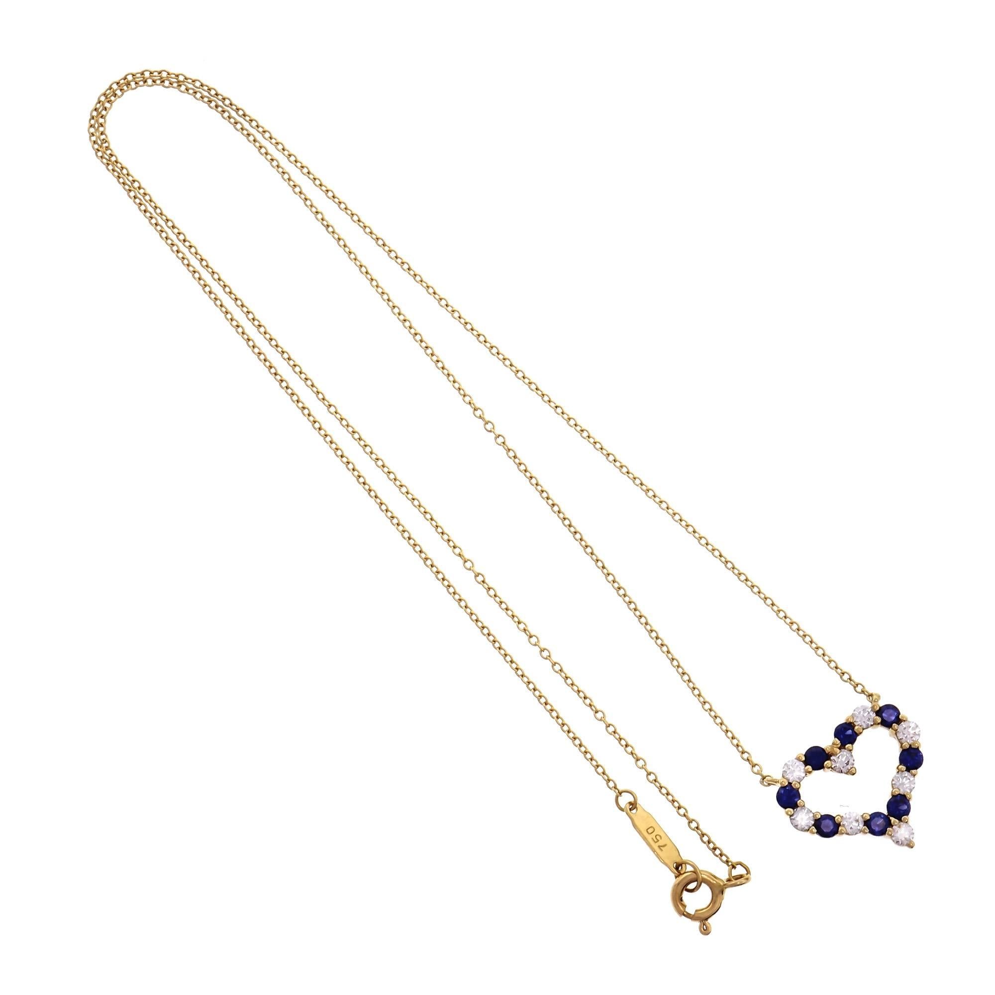 Tiffany & Co open heart Diamond Sapphire pendant and 18k yellow gold necklace. Stamped on both the chain and the heart.

8 round Ideal cut Diamonds, approx. total weight .36cts, F, VS
8 round top gem blue Sapphires, approx. total weight .55cts, VS,