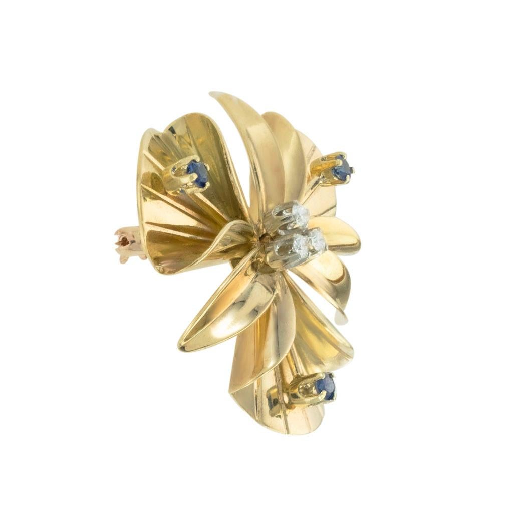 Tiffany & Co diamond sapphire and yellow gold brooch circa 1950.  *

SPECIFICATIONS:

DIAMONDS:  three round brilliant-cut diamonds totaling approximately 0.15 carat, approximately H color, VS clarity.

SAPPHIRES:  three round, faceted, blue