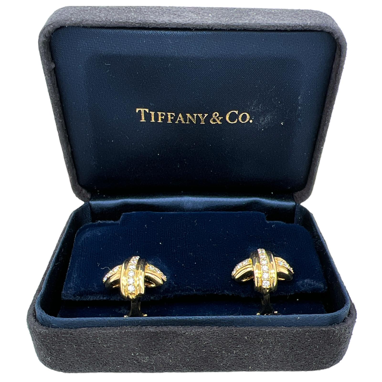 Tiffany & Co's iconic diamond X earrings are fashioned in 18 karat yellow gold. The earrings feature 30 round brilliant cut diamonds weighing approximately .75 carat total weight. The diamonds are graded F-G color and VS clarity. The earrings