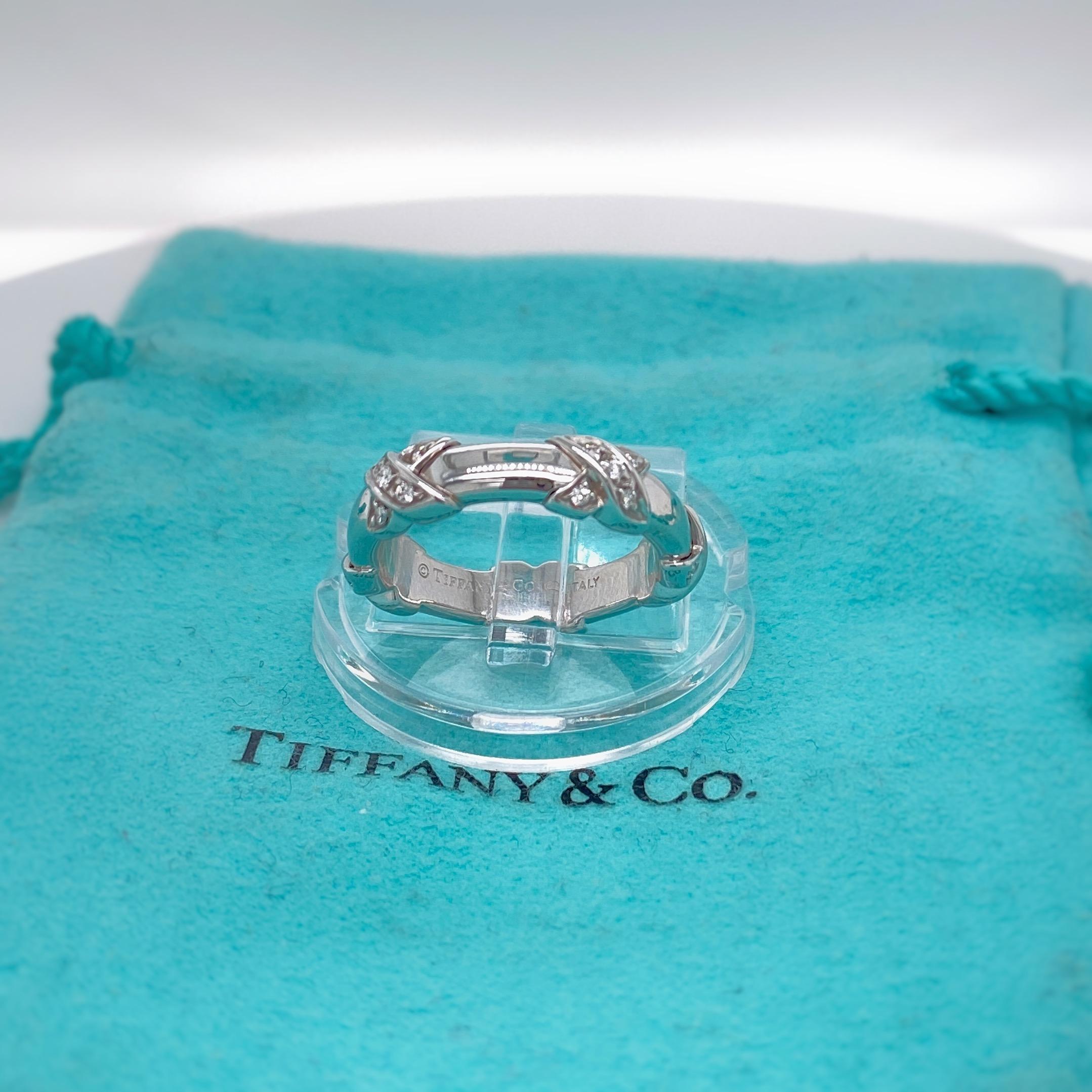 Tiffany & Co
Style:  Signature X Diamond Ring
Metal:   18 kt White Gold
Size:  4.5 
TCW:  0.15 tcw
Main Diamond:  Round Brilliant Cut Diamonds
Color & Clarity:  F - VS
Hallmark:  ©TIFFANY&CO.750 Italy
Includes:  T&C Jewelry Pouch
Retail: 