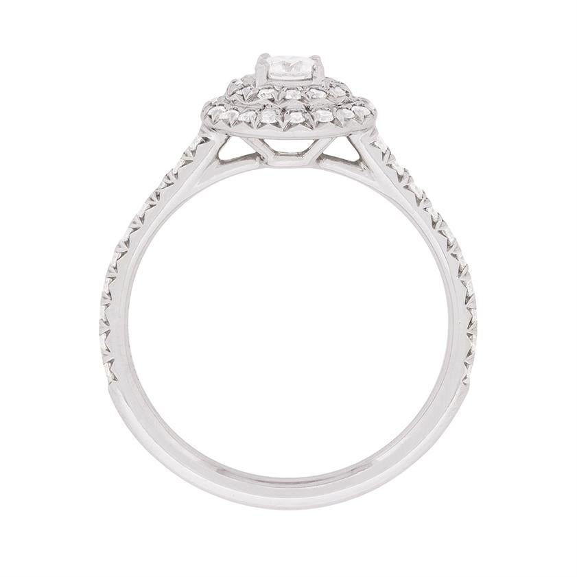 Featuring from the Tiffany & Co collection Soleste, this classic ring has a double halo of round brilliant diamonds around the centre stone, with further micro-set diamonds on the shoulders. There is a combined weight of 0.47 carat and the dazzling