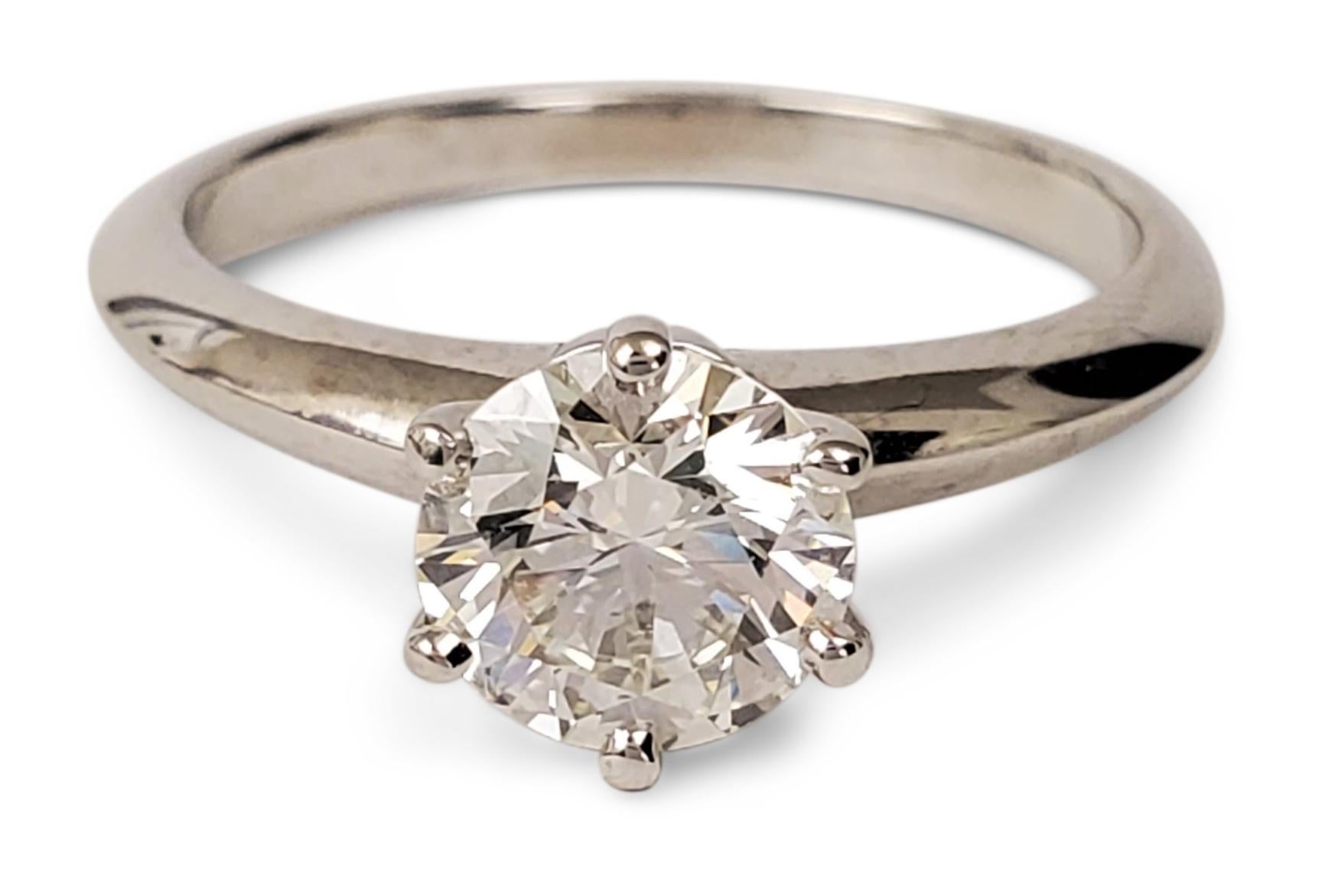 Authentic Tiffany & Co. engagement ring made in platinum set with a stunning 1.06ct round brilliant cut diamond, I color, VS1 clarity.  Cut and polish are graded Excellent. The symmetry is graded as Very Good and there is no fluorescence.  Stamped