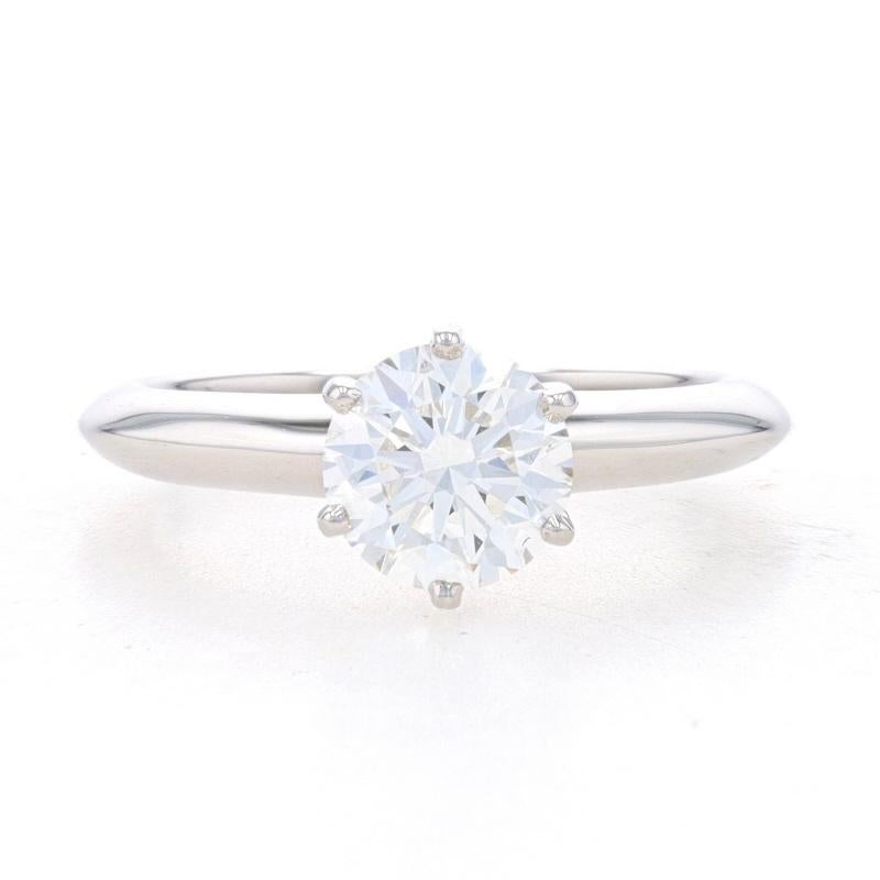 Retail Price: $18,000

Size: 5 3/4
Please contact us for a quote on re-sizing this ring.

Brand: Tiffany & Co.

Metal Content: 950 Platinum

Stone Information
Natural Diamond
Carat: 1.21ct
Cut: Round Brilliant
Color: H
Clarity: VS1
Stone Note: