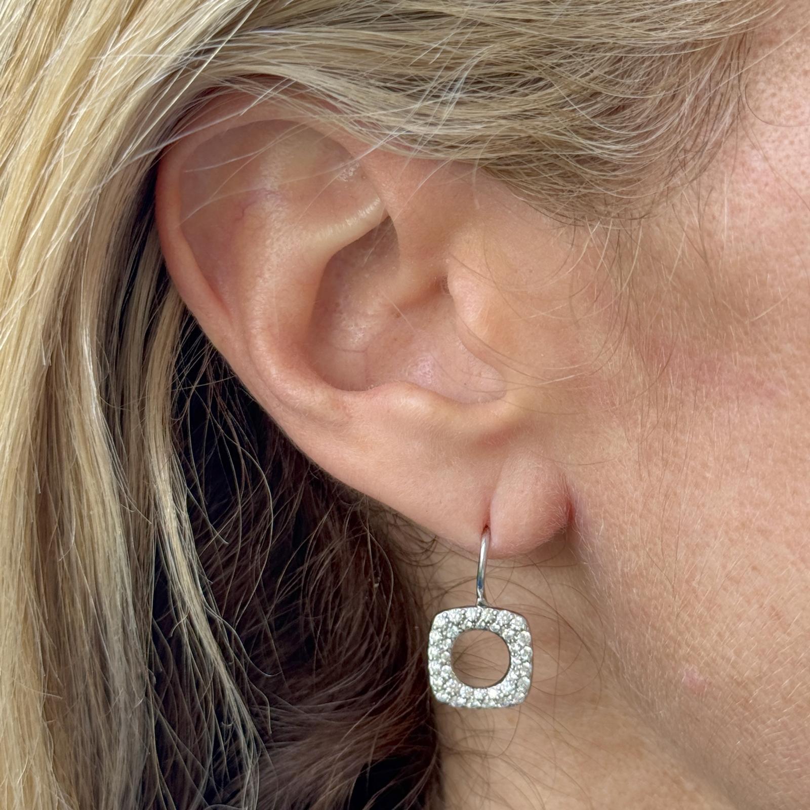 Contemporary and refined, these Tiffany & Co. drop earrings are crafted in 18 karat white gold with a clean open-square design. The geometric motif is accented by brilliant diamonds that add a subtle sparkle to the modern silhouette. Measuring 20mm