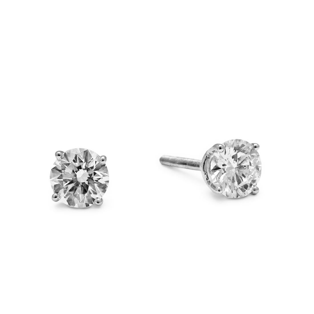 Authentic Tiffany & Co. stud earrings crafted in platinum and set with stunning round brilliant cut diamonds, weighing 2.24 carats total weight. The earrings have screw backs for pierced ears. Signed T&Co., PT950. Each earring is presented with its