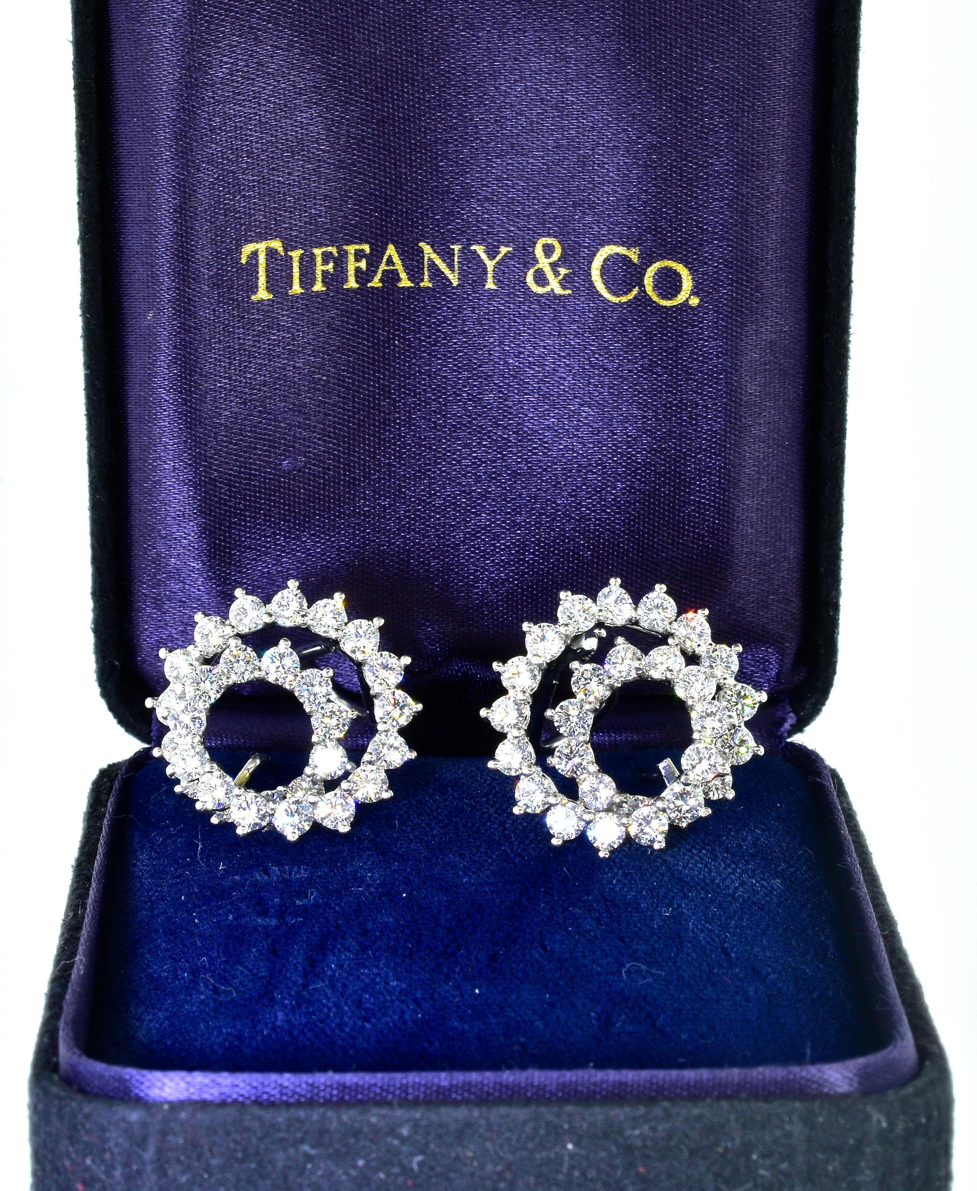 Tiffany & Co. diamond earrings in a swirl motif with fine white diamonds. The diamonds are colorless to near colorless, F/G and very to very very slightly included, VVS to VS.  The estimated diamond weight is 4.50 cts.  These earrings are platinum