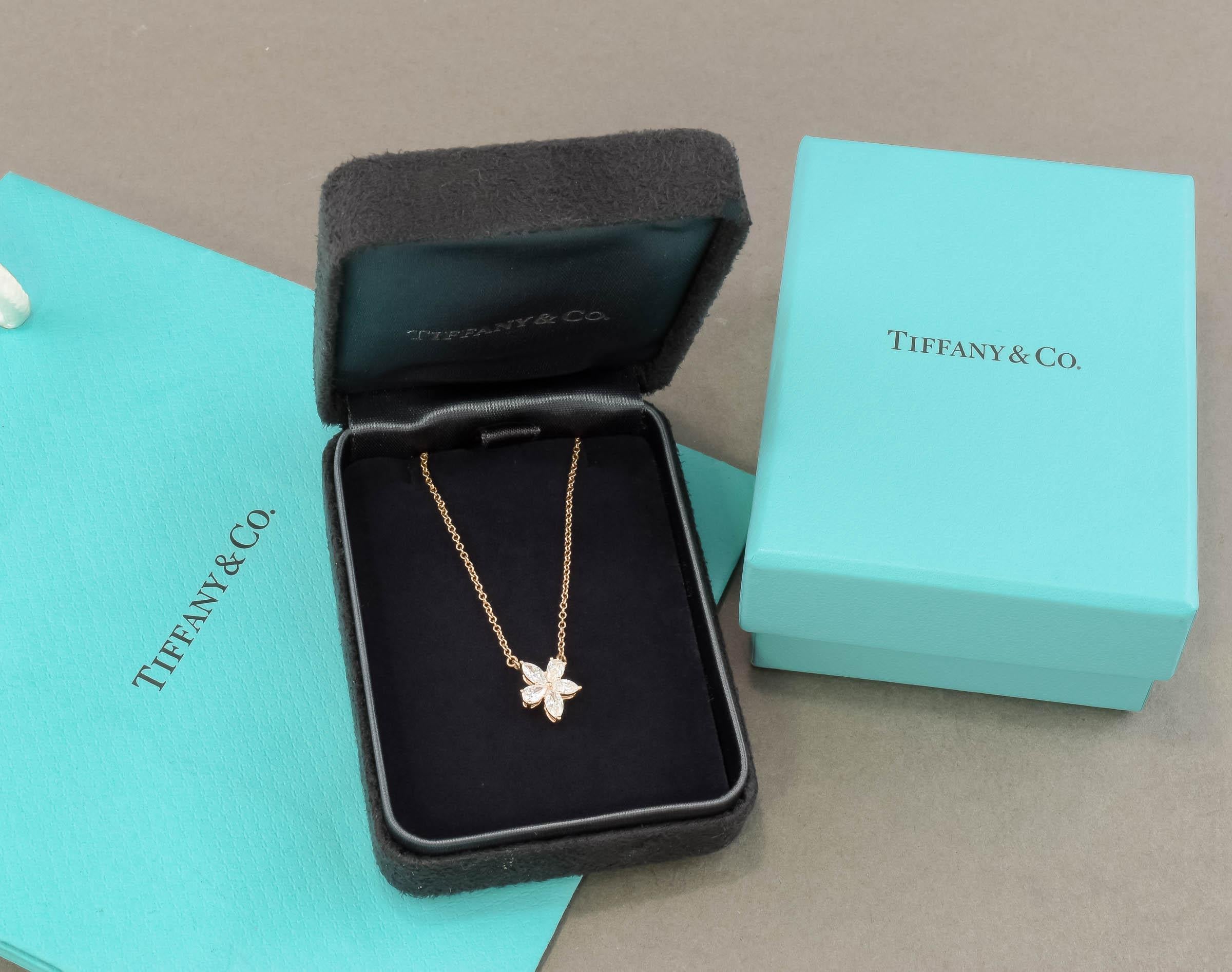 Offered is a very elegant estate Tiffany & Co. diamond necklace from their romantic Victoria collection.  One of the harder to find designs, this is a mixed cluster flower in pear and marquise cut diamonds set in 18K rose gold, with a total