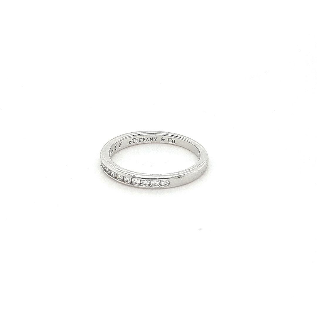 Unique features:
Tiffany & Co. wedding band finely crafted in platinum with a half circle of 15 channel set round brilliant cut diamonds.
Metal: Platinum
Carat: 0.22Ct 
Colour: D-G
Clarity: VS2
Cut: Round
Weight: 3.8 grams
Engravings/Markings: