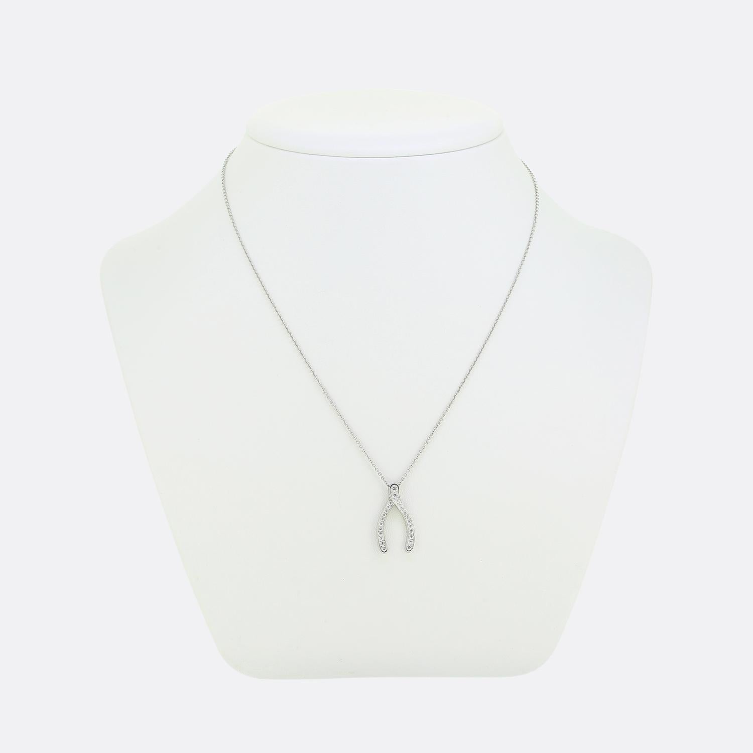 Here we have a refined necklace from the world renowned jewellery designer, Tiffany & Co. The design features a wishbone-shaped pendant encrusted with bright white round brilliant-cut diamonds. The pendant's gentle curves and sparkling surface