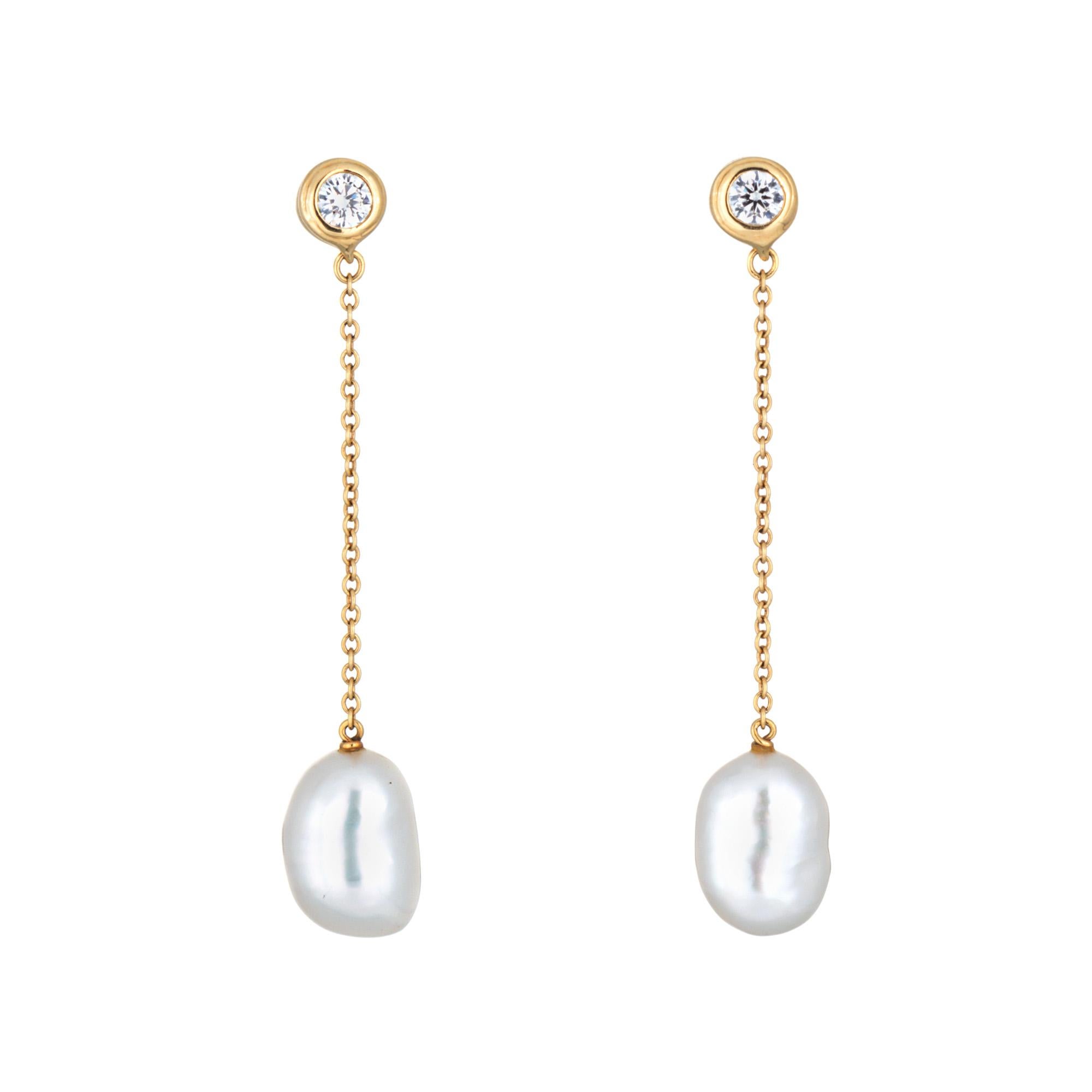 Finely detailed pair of pre-owned Elsa Peretti Tiffany & Co Diamonds by the Yard Pearl drop earrings crafted in 18k yellow gold. 

Diamonds total an estimated 0.10 carats (estimated at G-H color and VS1 clarity). Two cultured freshwater pearls