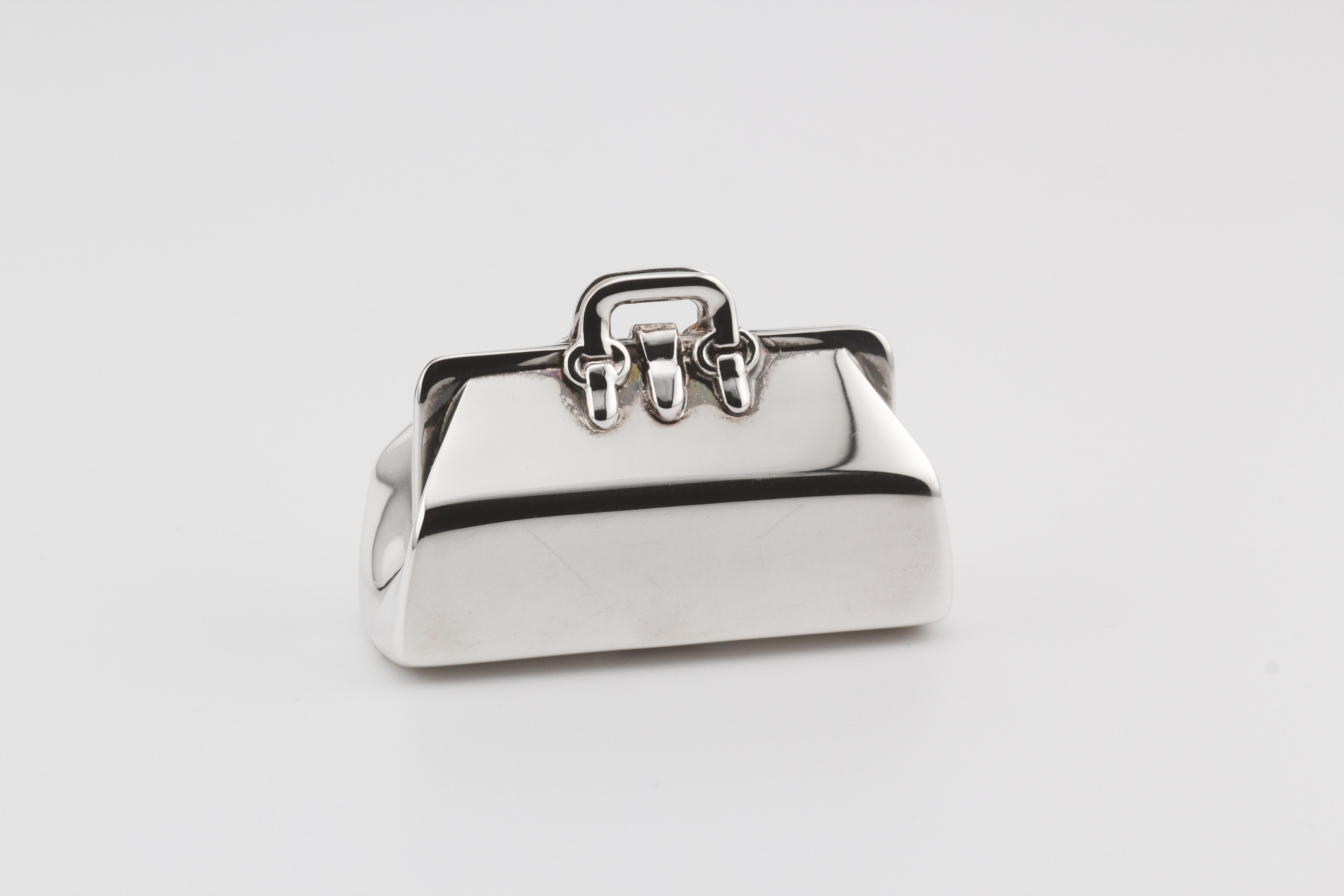 Introducing the Tiffany & Co. Doctor Bag Sterling Silver Pill Box—an exquisite blend of luxury and functionality. Crafted by the esteemed house of Tiffany & Co., this pill box takes inspiration from the iconic doctor bag, transforming it into a