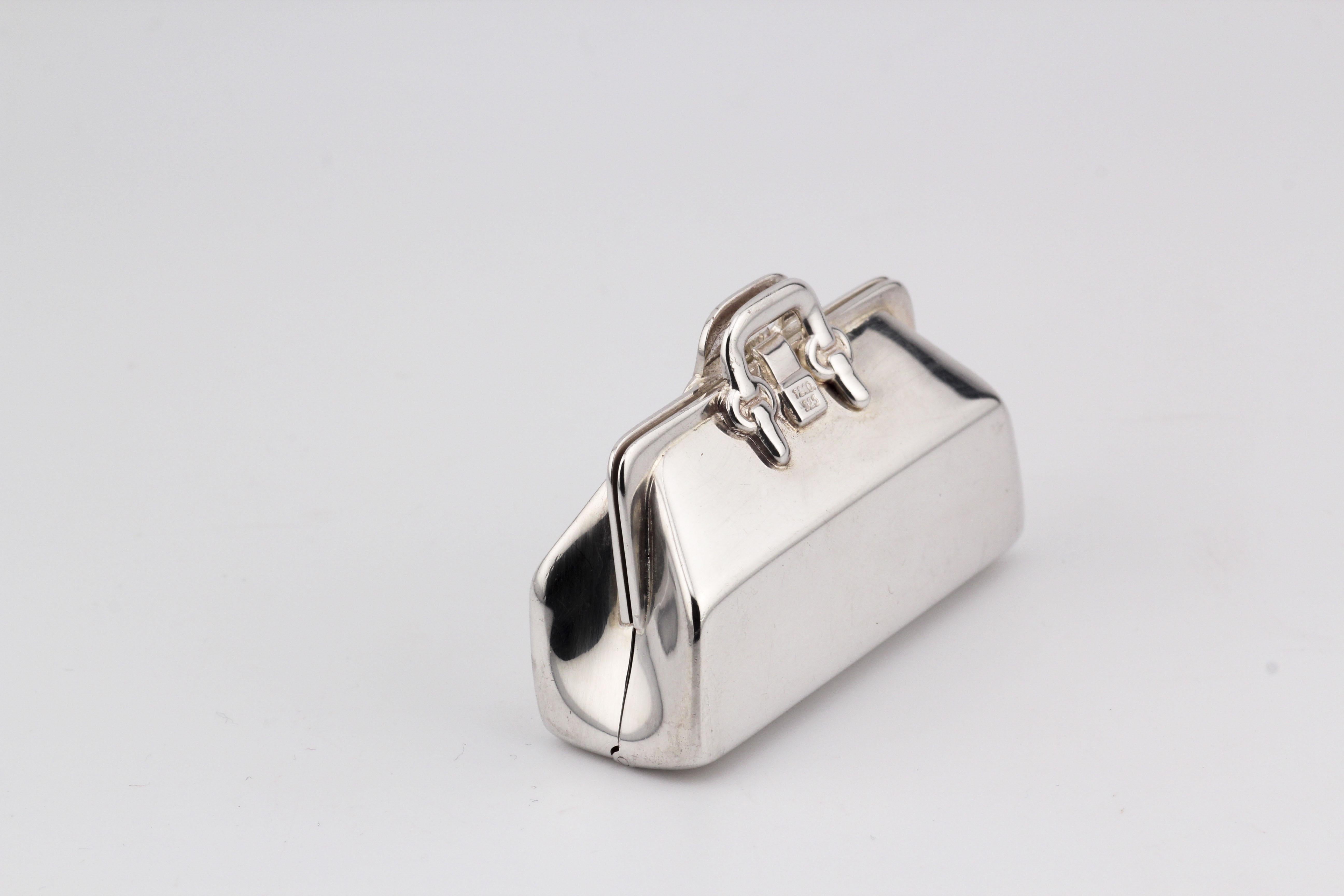 Introducing the Tiffany & Co. Doctor Bag Sterling Silver Pill Box—an exquisite blend of luxury and functionality. Crafted by the esteemed house of Tiffany & Co., this pill box takes inspiration from the iconic doctor bag, transforming it into a