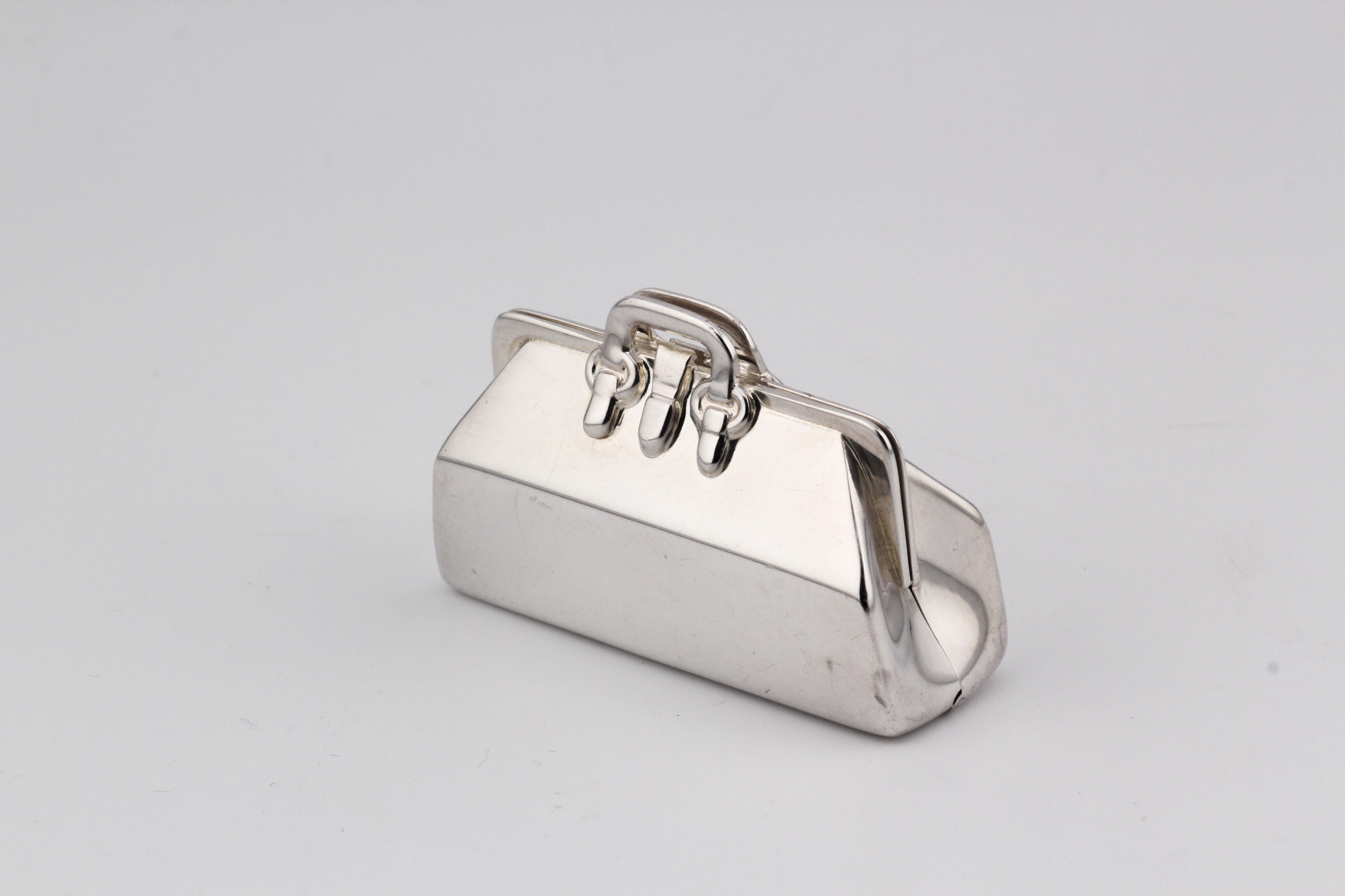 Introducing the Tiffany & Co. Doctor Bag Sterling Silver Pill Box—an exquisite blend of luxury and functionality. Crafted by the esteemed house of Tiffany & Co., this pill box takes inspiration from the iconic doctor bag, transforming it into a