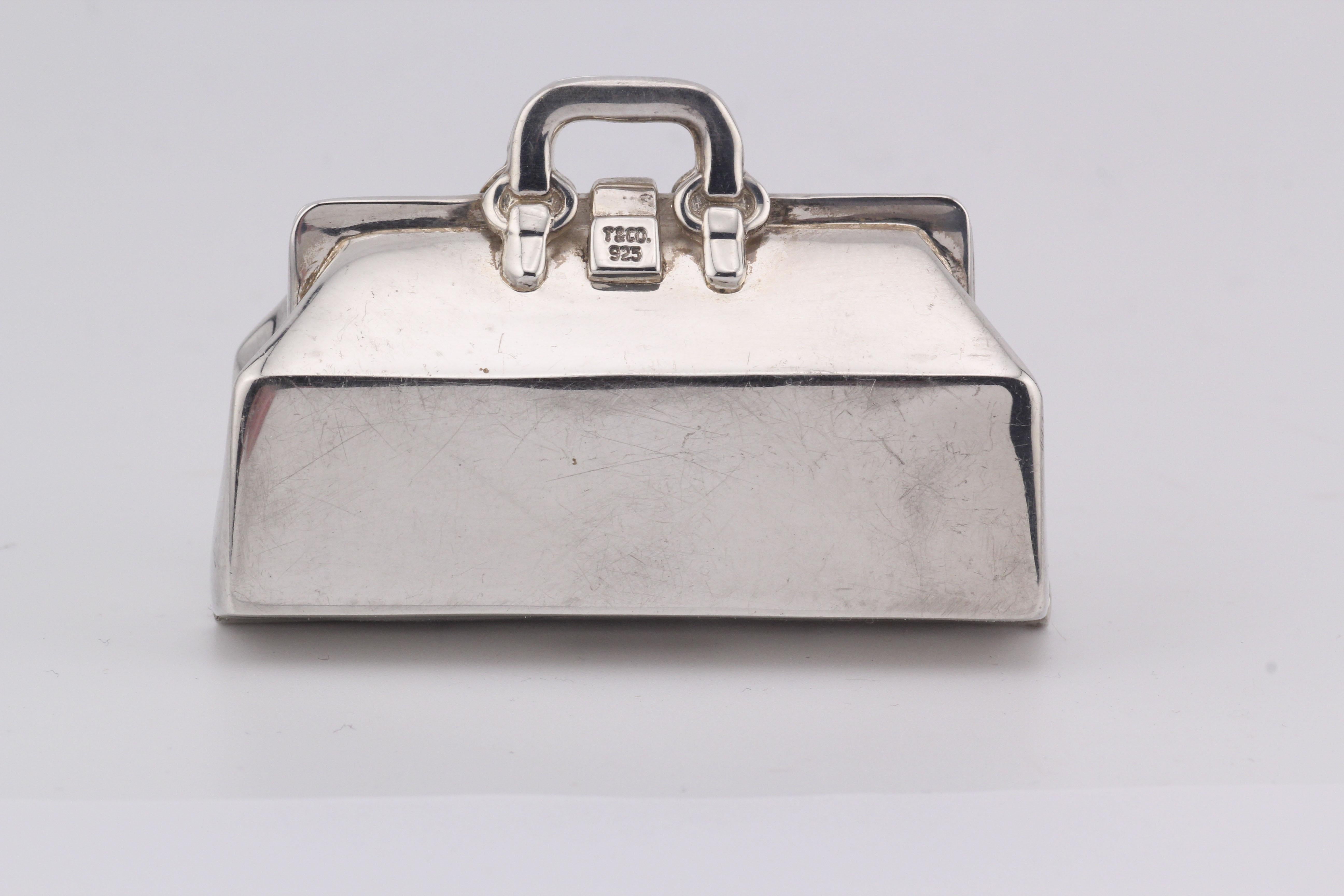 Introducing the Tiffany & Co. Doctor Bag Sterling Silver Pill Box—an exquisite blend of luxury and functionality. Crafted by the esteemed house of Tiffany & Co., this pill box takes inspiration from the iconic doctor bag, transforming it into a