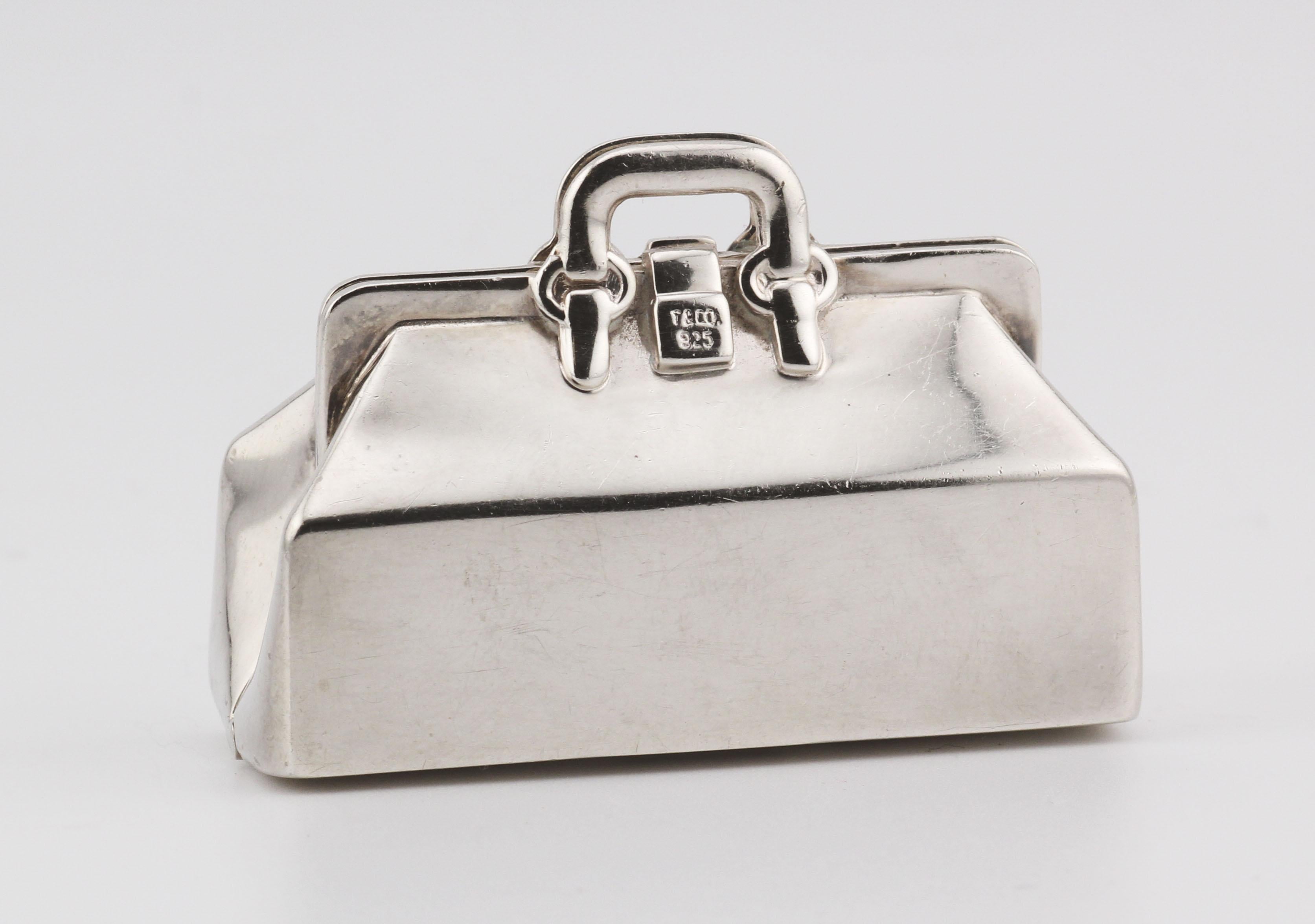 Introducing the Tiffany & Co. Doctor Bag Sterling Silver Pill Box—an exquisite blend of luxury and functionality. Crafted by the esteemed house of Tiffany & Co., this pill box takes inspiration from the iconic doctor bag, transforming it into a