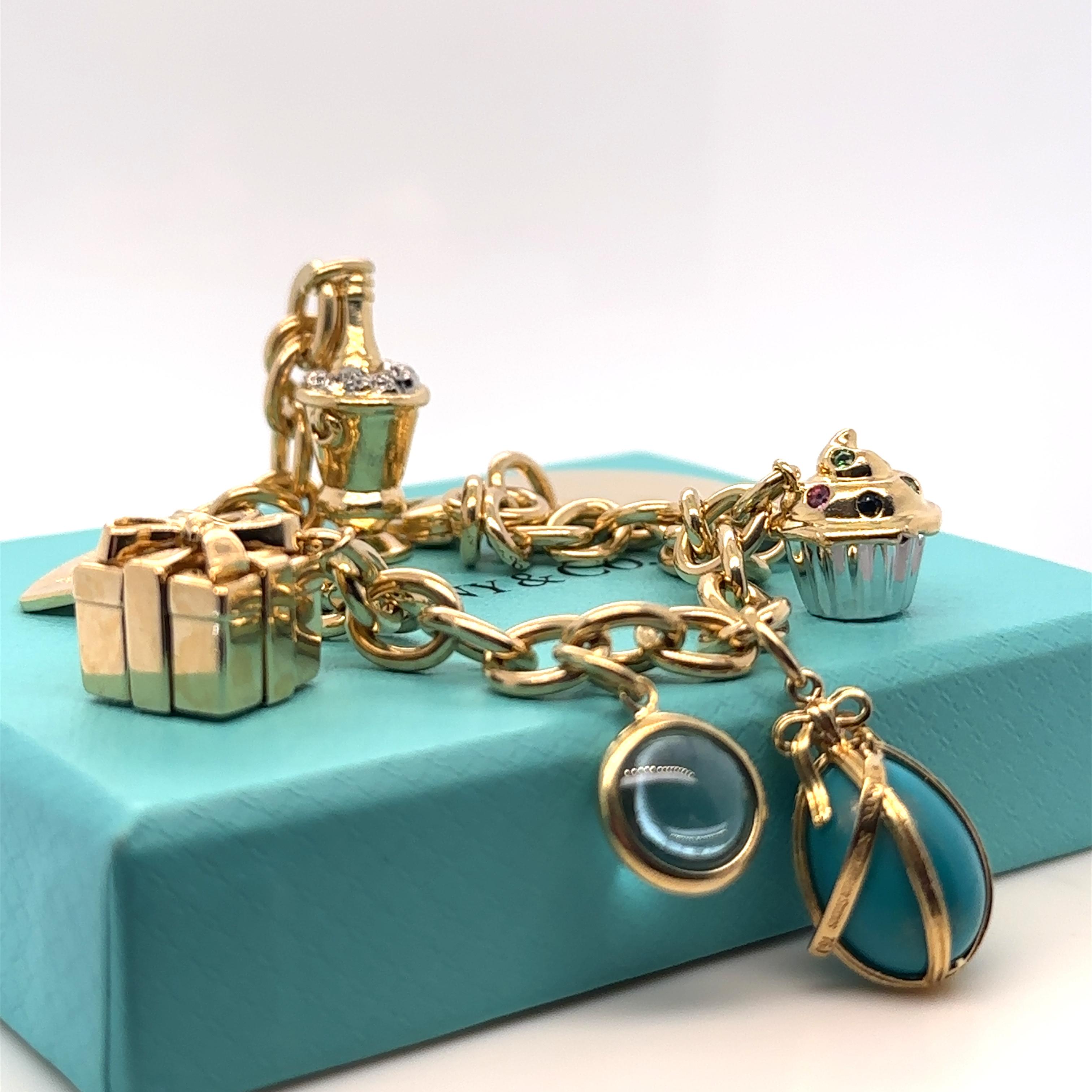 Unique features: 

A Tiffany & Co Dog Chain link Bracelet & Heart Charm with vintage charms (8) in 18ct Gold.

Charms

Tiffany & Co Schlumberger Turquoise Egg Charm Estate 18ct Yellow Gold Pedant (RRP $5,855) 4.2 grams, signed T&Co 750 Schlumberger
