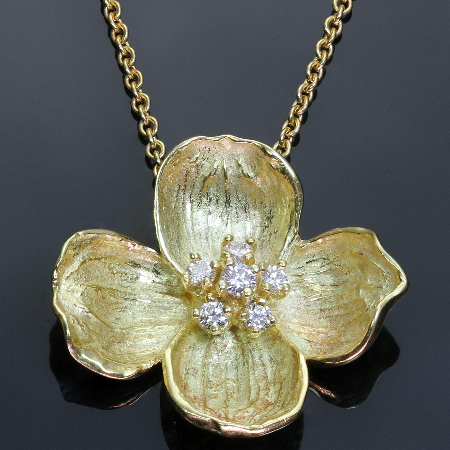 This gorgeous Tiffany & Co. necklace from the delicate floral Dogwood collection features the classic flower design crafted in 18k yellow gold and set with round brilliant F-G VVS2-VS1 diamonds weighing an estimated 0.30 carats. Made in United