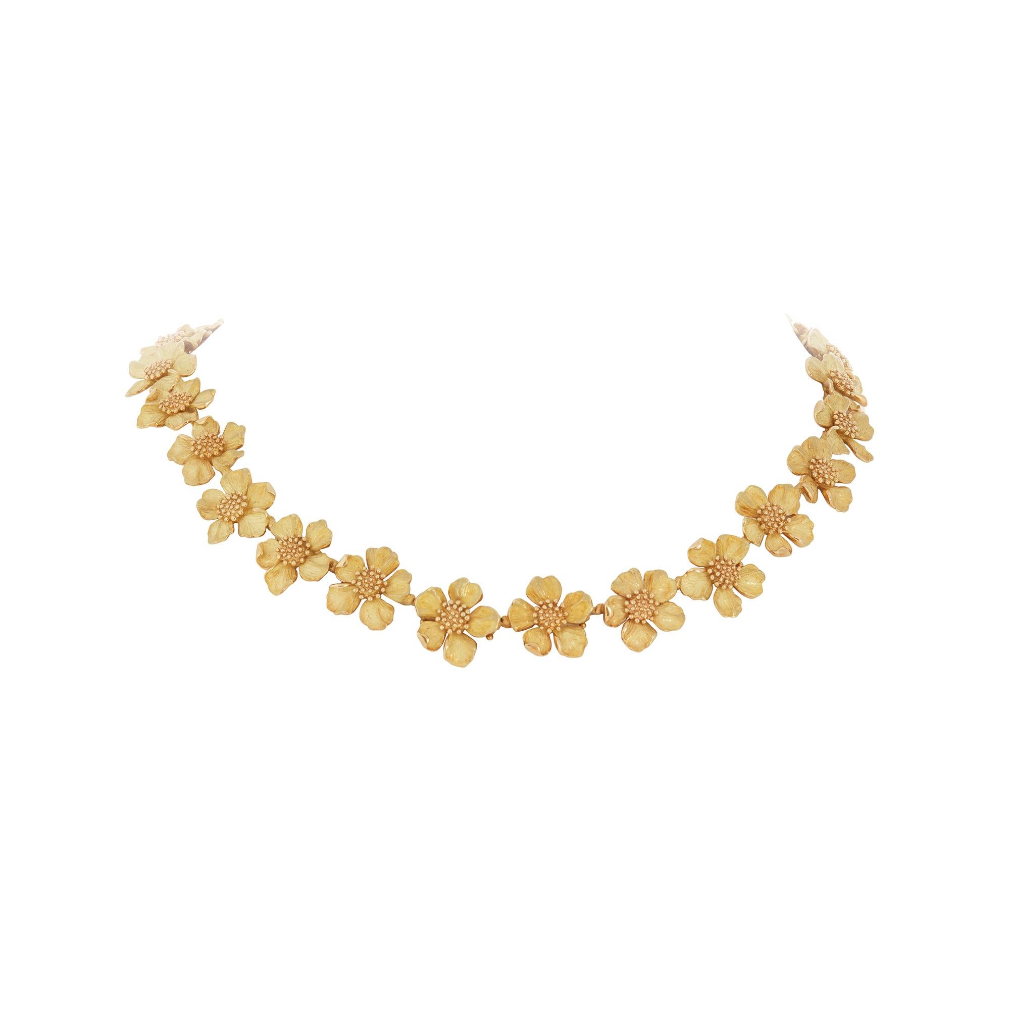 Authentic Tiffany & Co. necklace from the iconic Dogwood Collection crafted in textured 18 karat yellow gold. A timeless classic featuring delicate floral links in the shape of dogwood flowers.  Signed Tiffany & Co., Tiffany Classics, 750. The