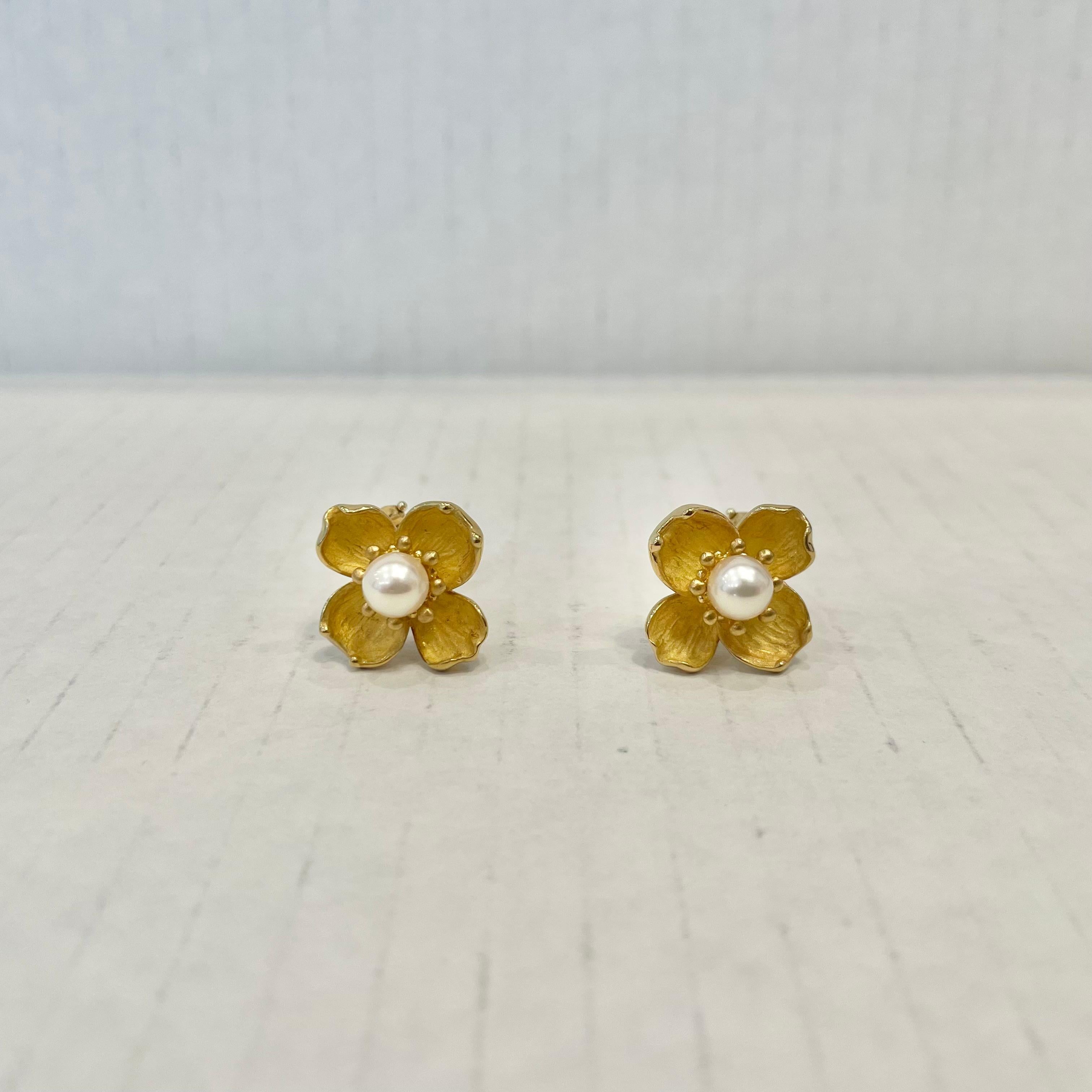 Beautiful pair of Tiffany & Co. earrings each featuring stunning fresh water pearls set in the middle of bloomed 18k yellow gold dogwood flowers. Painstaking attention to detail was given to the petals of each flower with the backs and front trim