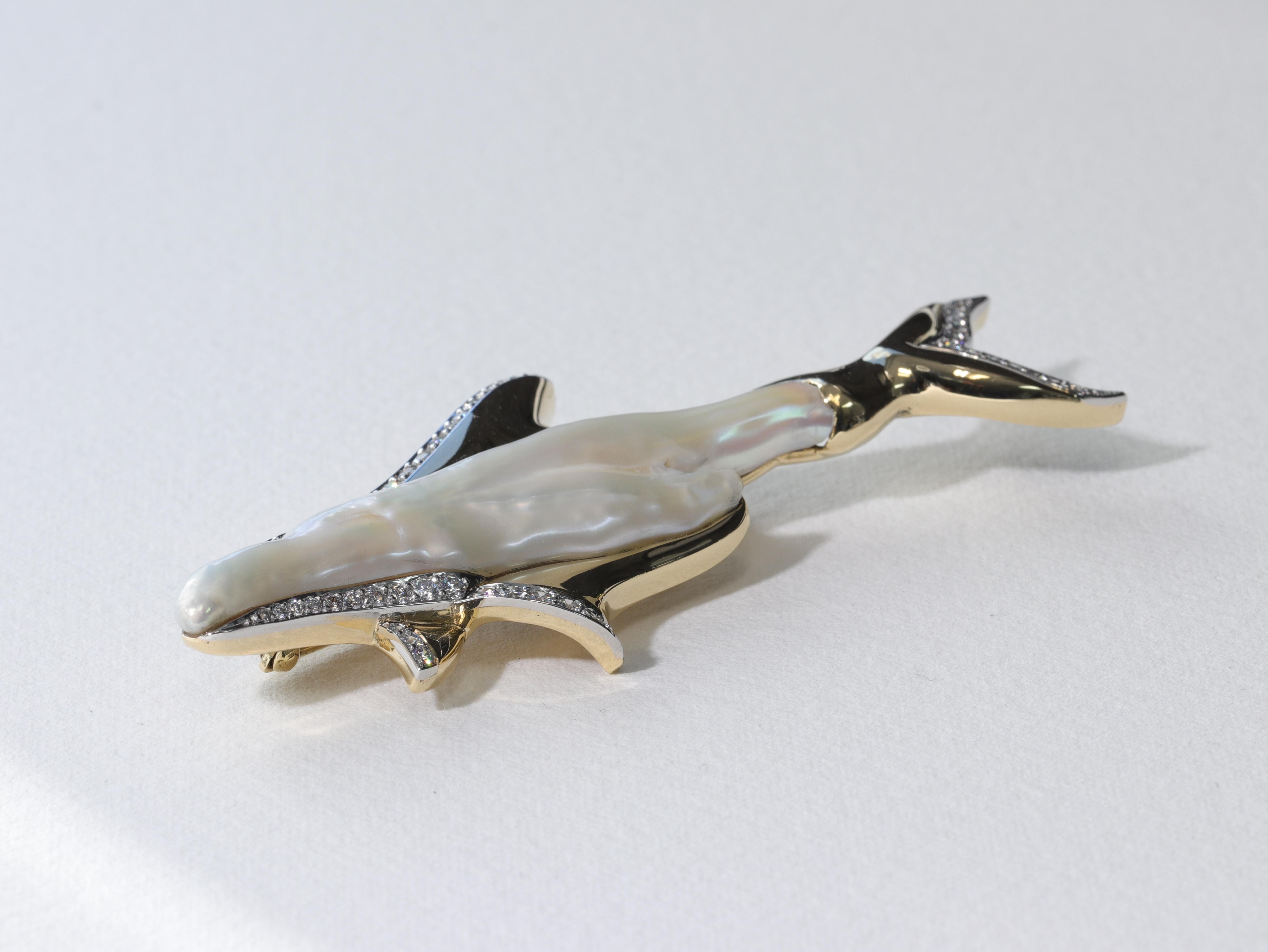 This truly one of a kind Tiffany & Co. brooch features a baroque natural pearl as the central design feature emulating the body and nose of a dolphin with additional features masterfully crafted in 18 karat yellow gold, platinum and colorless
