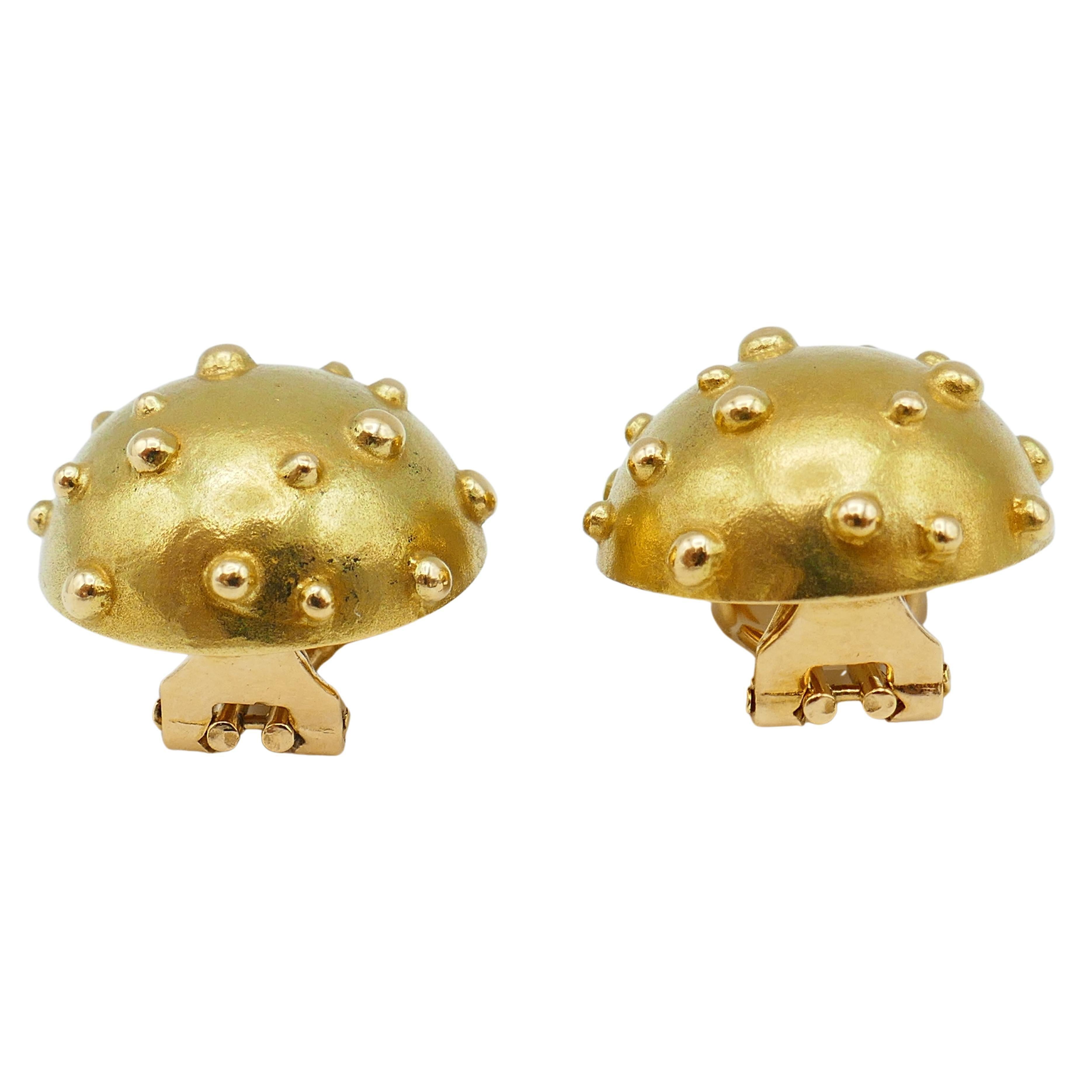 A cute yet refined pair of Tiffany & Co. Dot Mushroom gold earrings. 
The earrings have simple, pure look, but they are fun, eloquent and visible by design.
Note a dome convex shape and the gold color. The latter is subtle and carries a great