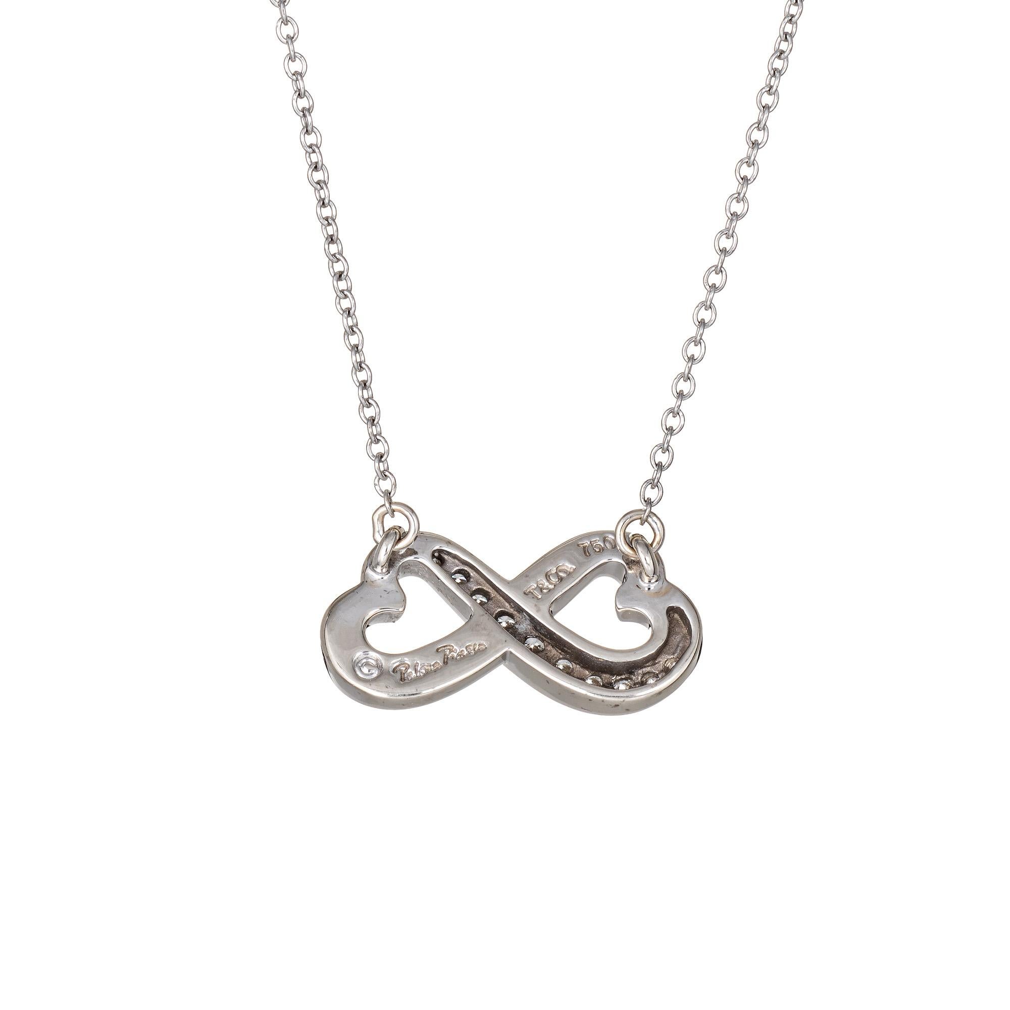 Elegant and finely detailed pre owned Tiffany & Co double heart diamond necklace crafted in 18 karat white gold.  

10 diamonds total an estimated 0.10 carats (estimated at F-G color and VVS2 clarity).

The double heart pendant is attached to a 16