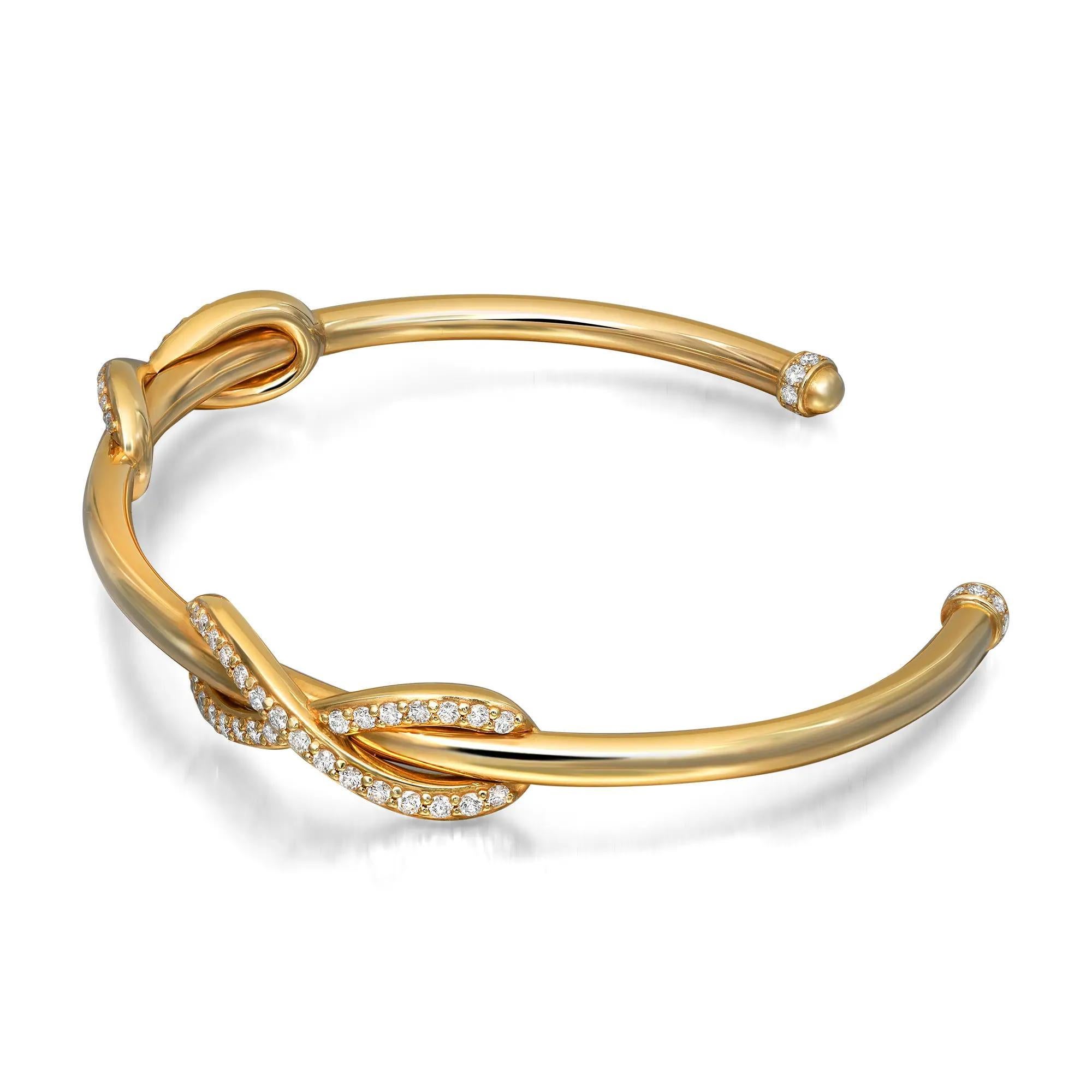 This gorgeous Tiffany & Co. cuff bracelet is crafted in solid 18K yellow gold. It features a double infinity design encrusted with bright white round brilliant cut diamonds with exceptional brilliance. This bracelet has a wonderful highly polished