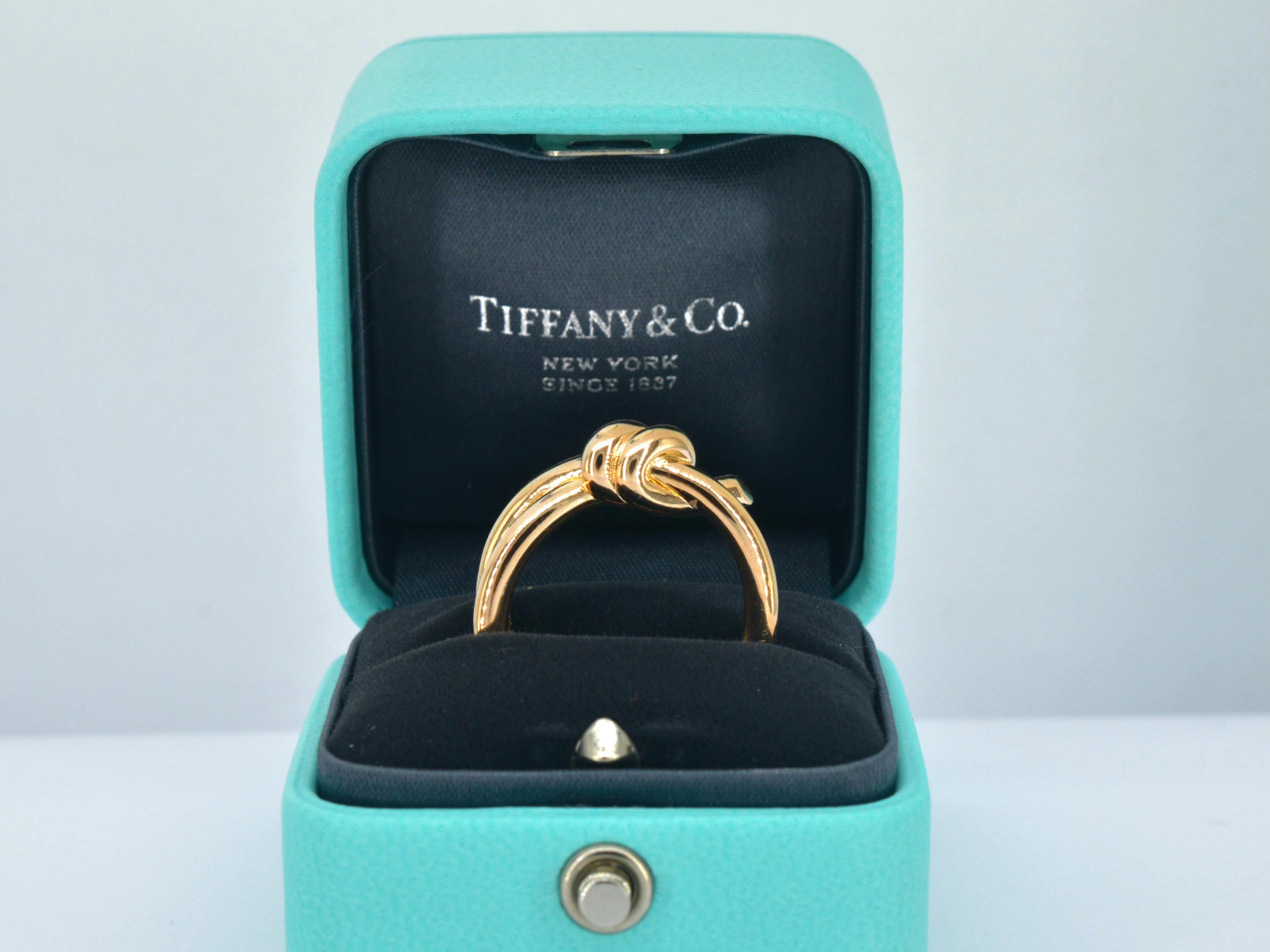A symbol of elegance and style, this Tiffany & Co. Double Knot rose gold ring is a true masterpiece. Crafted from lustrous 18-karat gold 750, this exquisite ring weighs 11 grams and is custom-sized to a comfortable 56 - 17.75 mm. Its unique design,