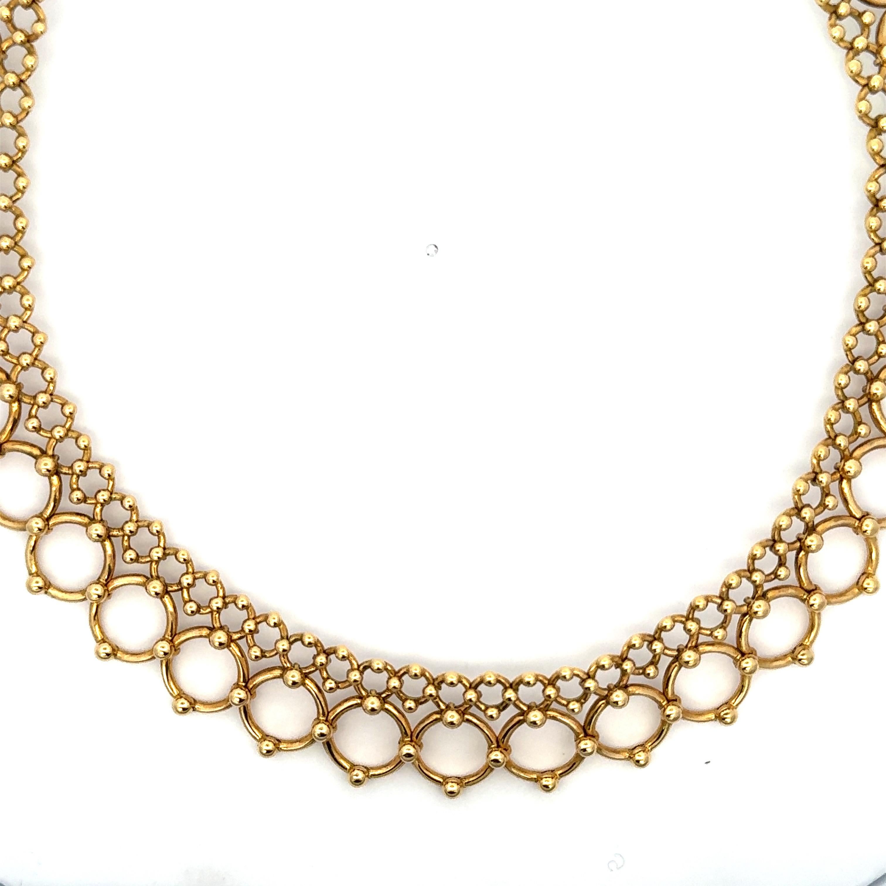 Signed Tiffany & Co, this necklace featuring a double row of graduated links weighing 73.9 grams in 18 yellow gold. 