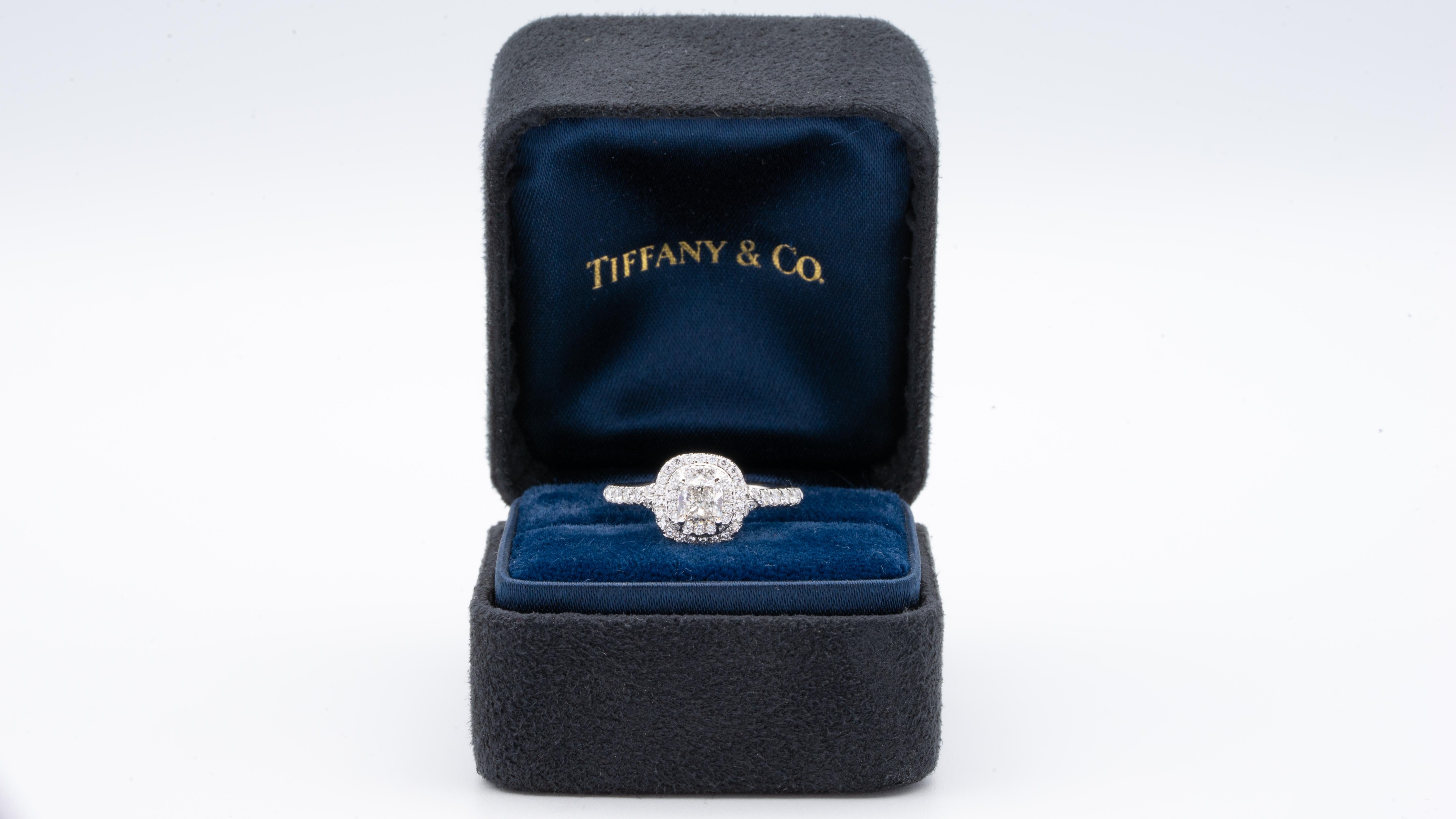 Tiffany & Co. Soleste engagement ring with an Excellent cut 0.49 ct cushion center , F Color, VS1 clarity finely crafted in a platinum double row halo design with round brilliant cut bead set diamonds.
Includes Original Tiffany Certificate and