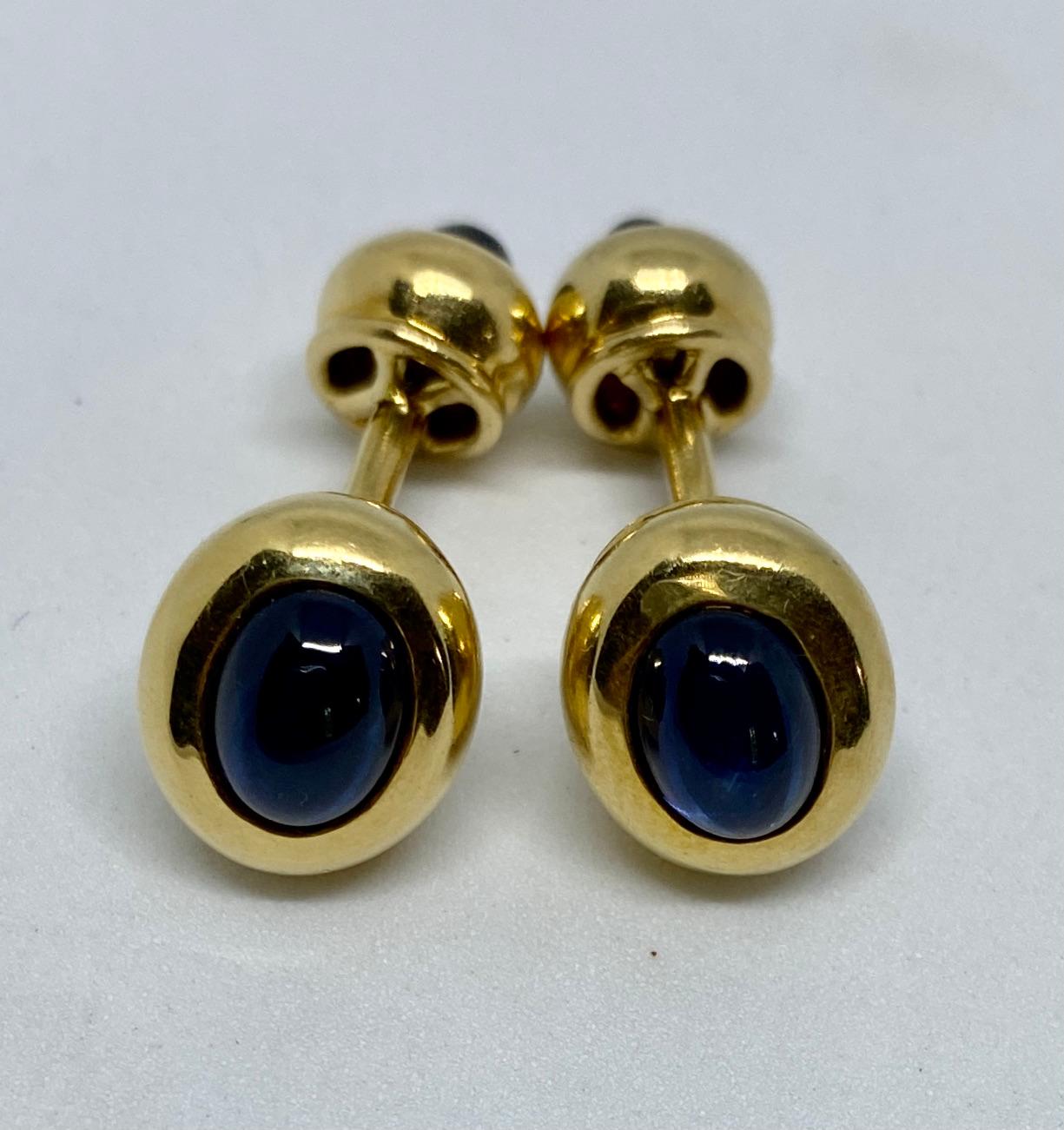 Handsome, beautifully made, double-sided cufflinks in 18K yellow gold featuring four deep blue sapphires.

The oval cufflink faces measure 12.3 by 10.6mm; the backs measure 9.1 by 8.2mm. Together the cufflinks weigh 13.87 grams.

The cufflinks are
