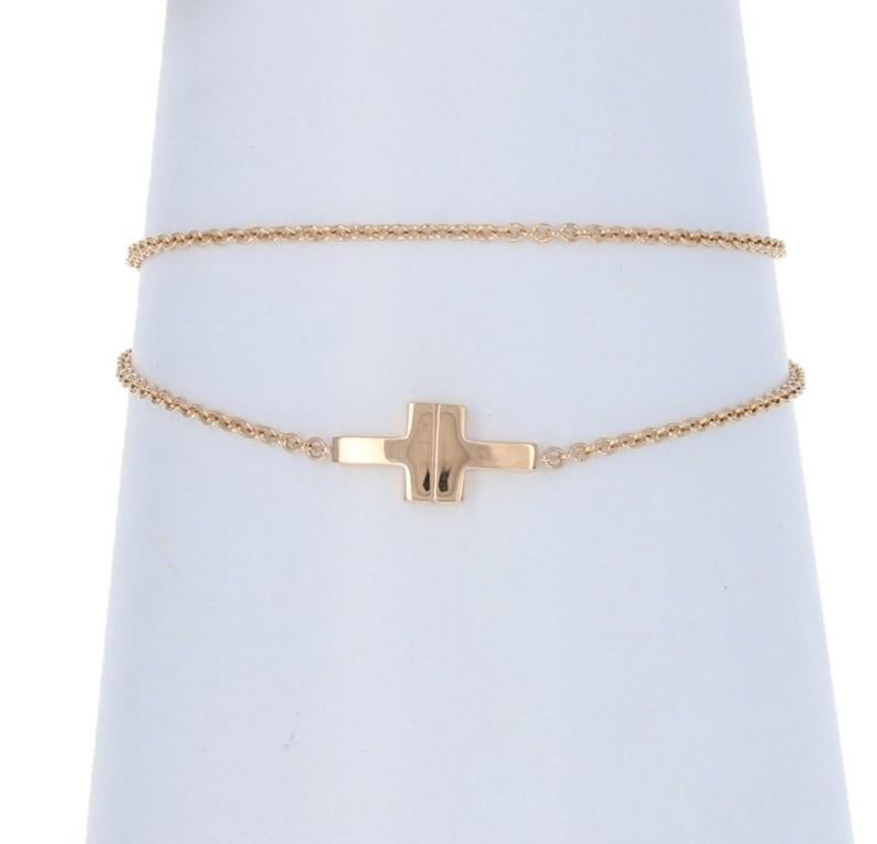 Originally retailing for $850, this elegant designer bracelet is being offered here for a much more wallet-friendly price.

Brand: Tiffany & Co. 
Collection: Tiffany T
Size: Medium

Metal Content: Guaranteed 18k Gold as stamped
Chain Style: Cable