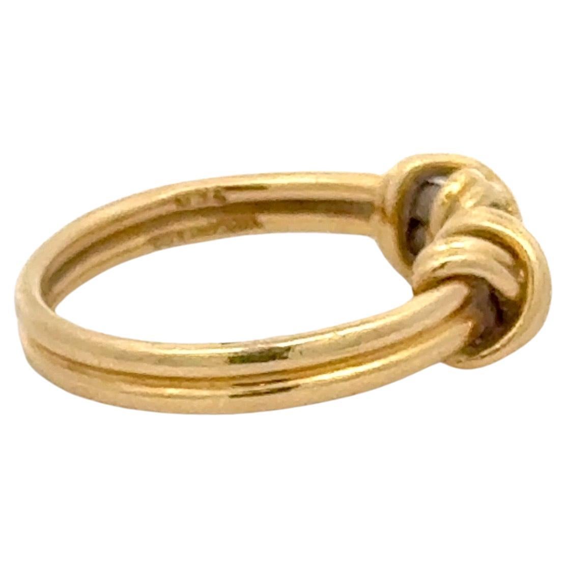 Tiffany & Co, 18 karat yellow gold band featuring a double 'X' design.
5.4 Grams 
Size 4