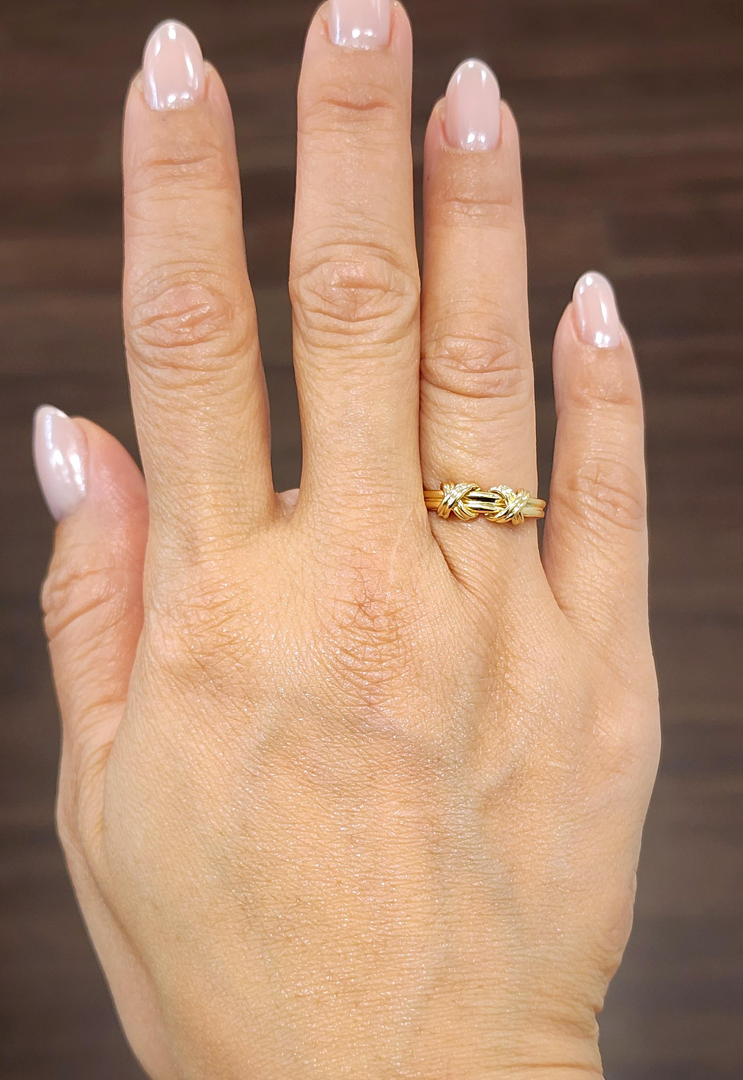 This exquisite fashion ring by Tiffany & Co. showcases a contemporary design in 18k yellow gold. Crafted in 1990, the ring features an elegant 2 knot motif, symbolizing unity and strength. Perfectly sized at 3.5, it offers a sleek and sophisticated