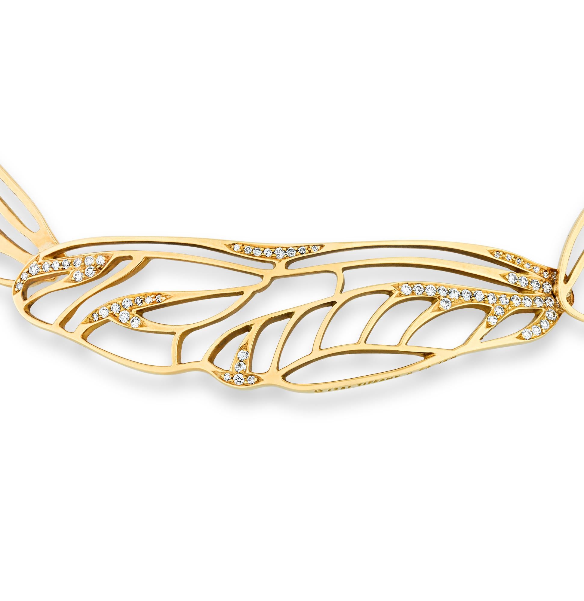 This enchanting 18K yellow gold necklace by Angela Cummings for Tiffany & Co. showcases the iconic jeweler's timeless craftsmanship. The design features delicate dragonfly wings formed from gold, adorned with pavé set diamonds totaling approximately