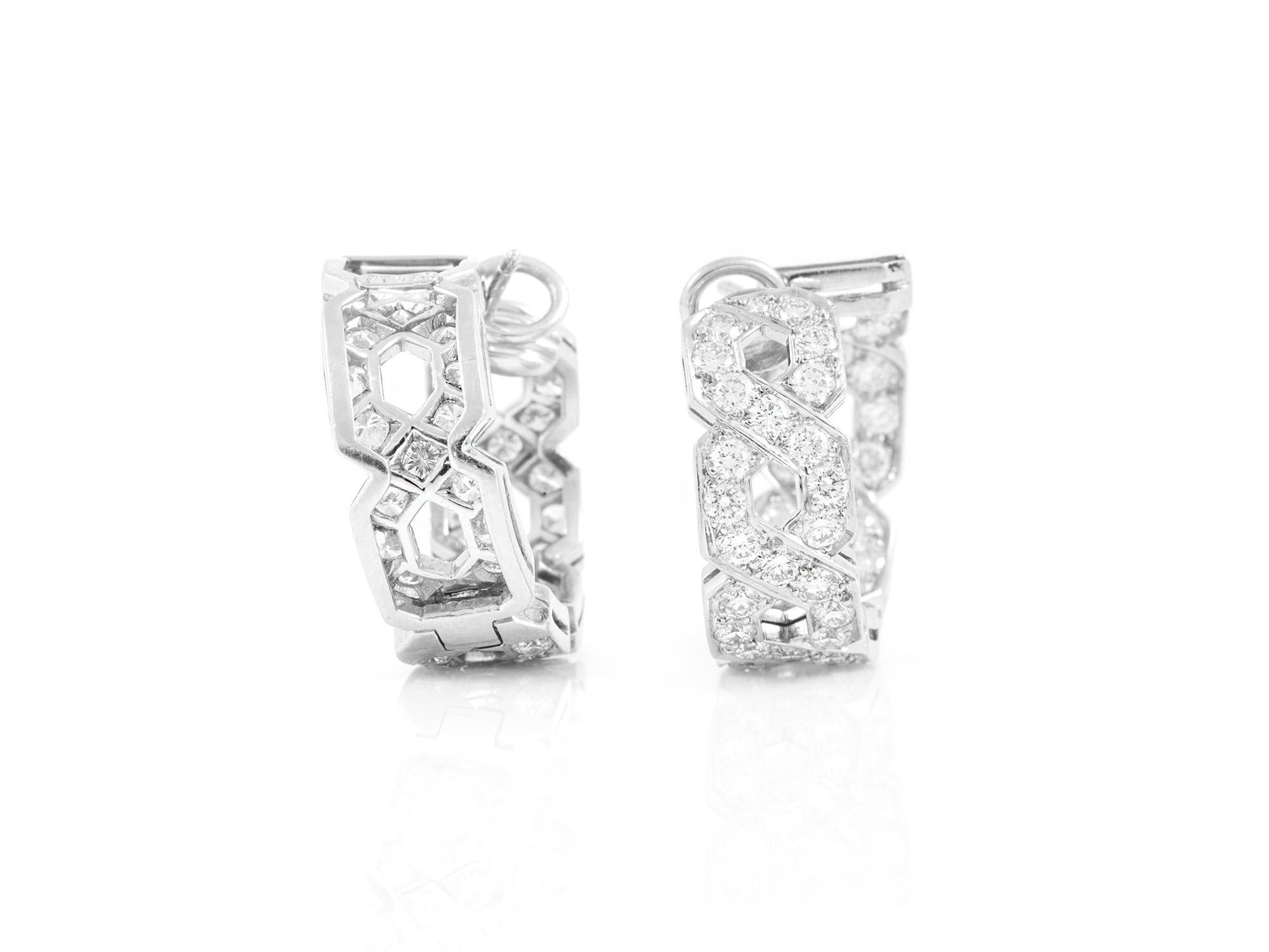 Tiffany & Co. earrings finely crafted in platinum with diamonds. 