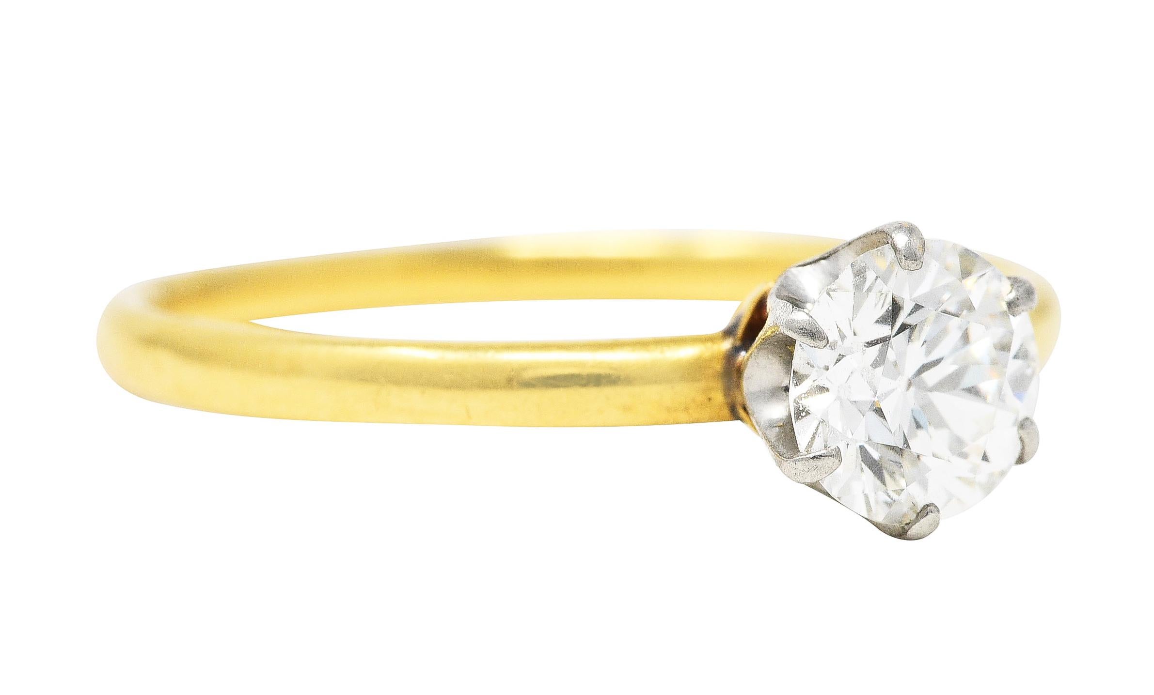 Designed as the iconic Tiffany setting with a six prong platinum head. Featuring an old European cut diamond weighing approximately 0.61 carat - H color with VS2 clarity. Completed by a sleek polished yellow gold shank. Tested as platinum and 18