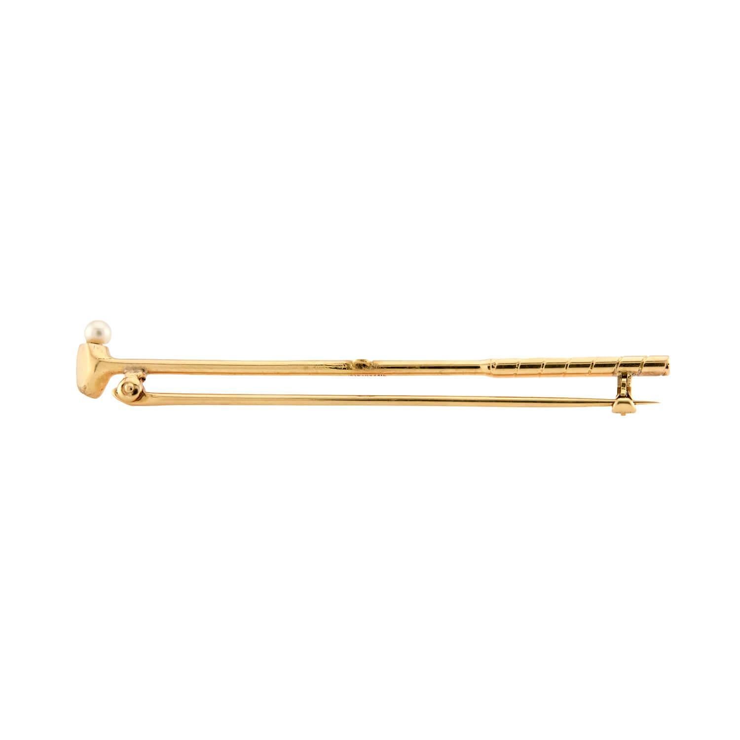 A beautiful gold pin by legendary jeweler Tiffany & Co. from the Edwardian (ca1900s) era! Crafted in vibrant 14k yellow gold, this pin depicts a golf club. The golf club is smooth and simple, and the grip of the piece features a ribbed texture,